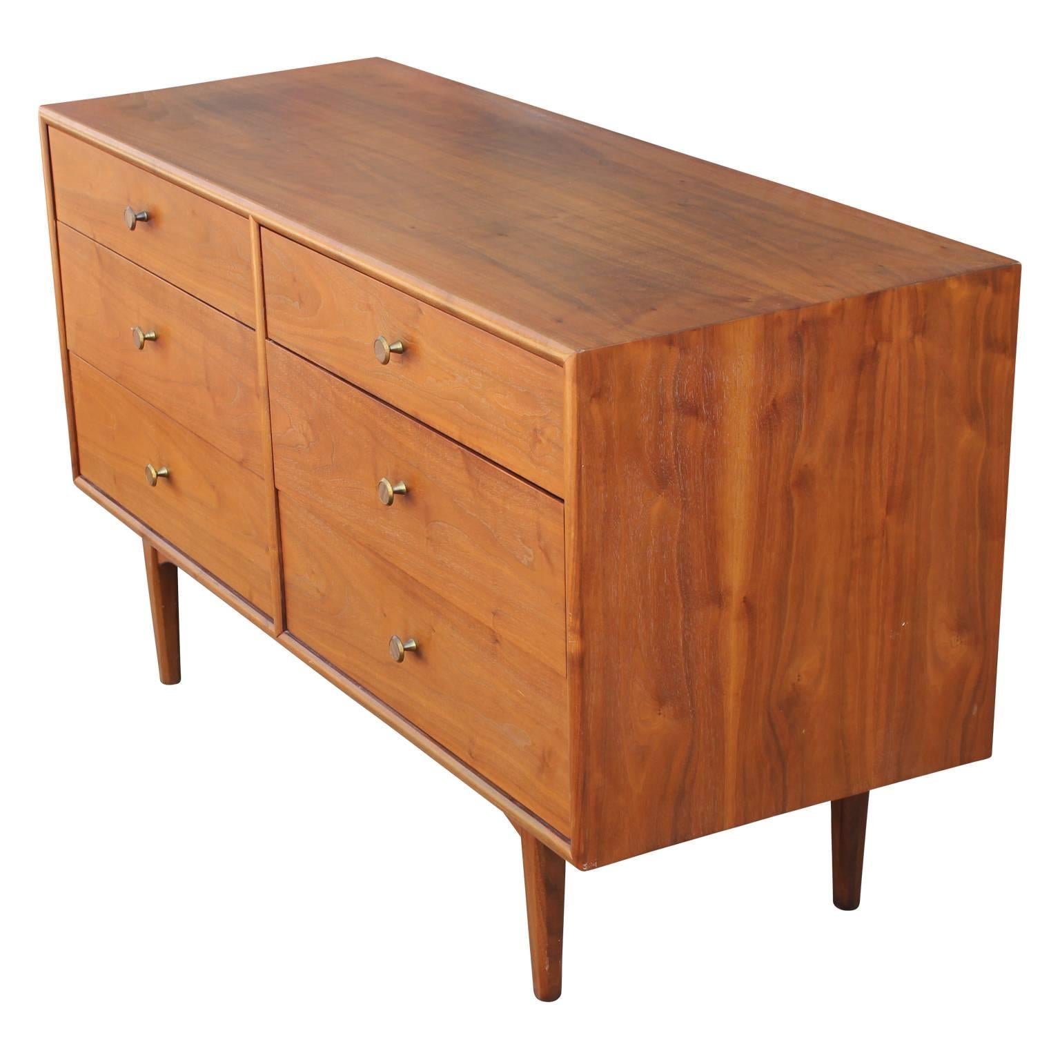 Iconic Drexel declaration walnut six-drawer dresser designed by Kipp Stewart and Stewart McDougall. Features brass and faux bamboo pulls. Beautiful addition to any modern or mid-mod space.