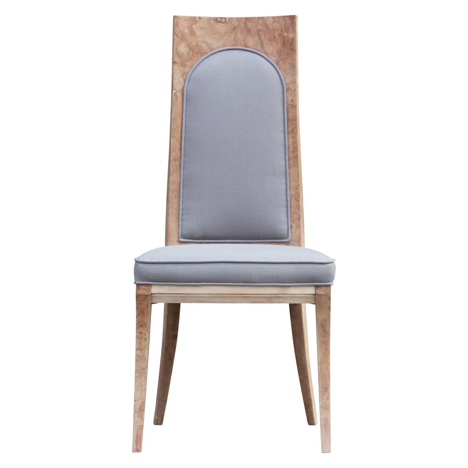 Stunning set of eight modern or Hollywood Regency dining chairs by Mastercraft freshly reupholstered in a light grey woven fabric and bleached burl or carpathian elmwood. The two end chairs have arms while the remaining six are armless.