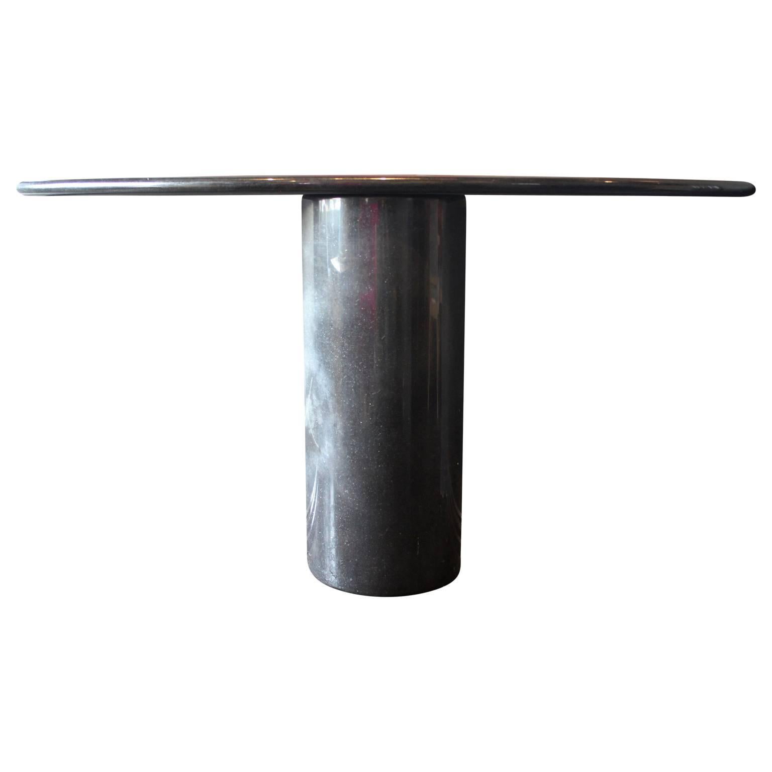 Gorgeous modern Italian demilune console/entryway pedestal table made out of black / dark grey marble. Absolutely stunning in person. There is a variation in the base that makes a line but is structurally sound and does not appear to be a