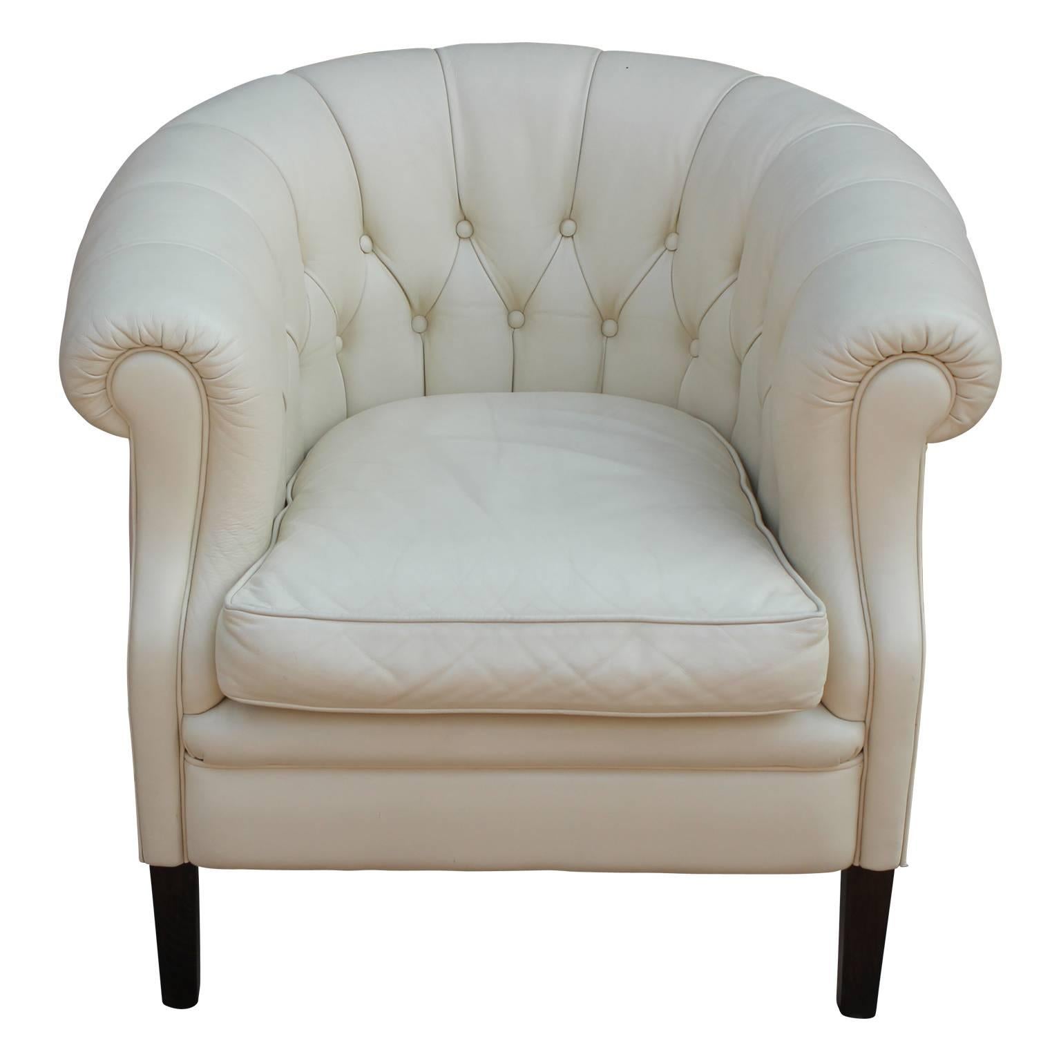 Pair of modern white leather tufted Chesterfield style lounge chairs with black legs. Hollywood Regency style.
