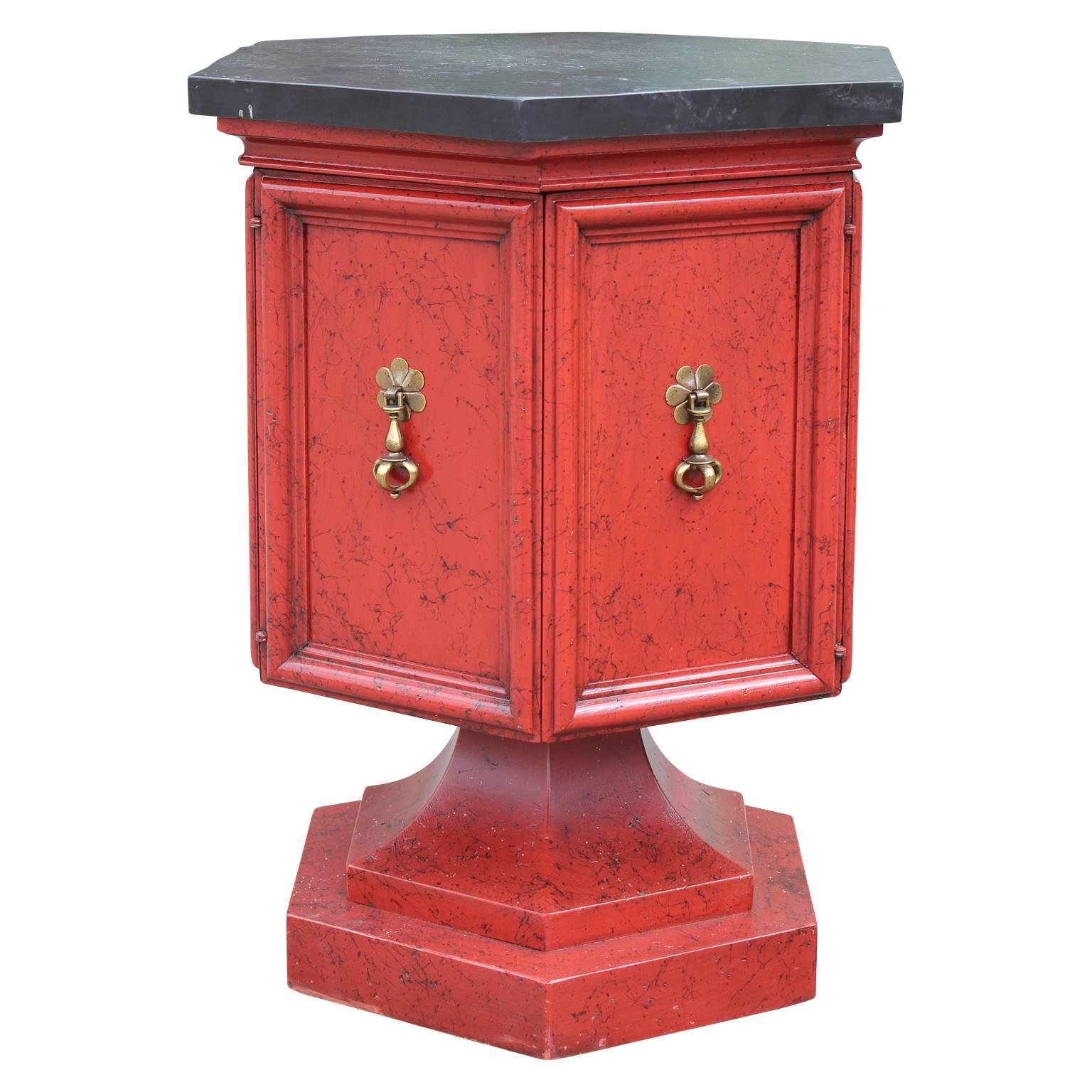 Pair of Hollywood Regency Hexagon slate top red and black pedestal side or end tables with brass hardware. The two doors open to reveal a small cabinet space.