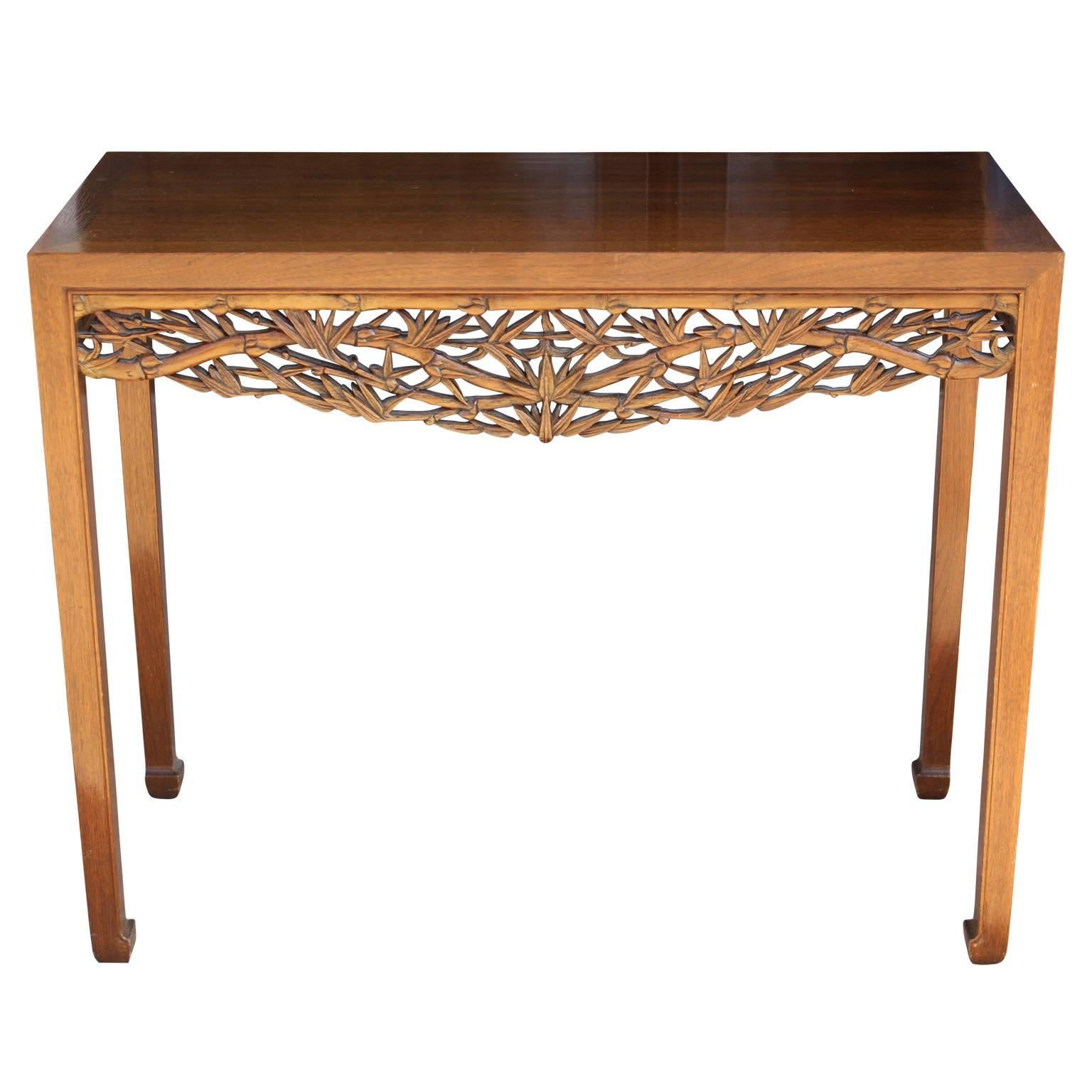 Unique modern console or entryway table with intricate hand-carved Asian motifs. Also features horse-hoof feet displaying a distinct Ming furniture style.  In nice vintage condition. The original clear lacquer has some patina to it. For detail shots