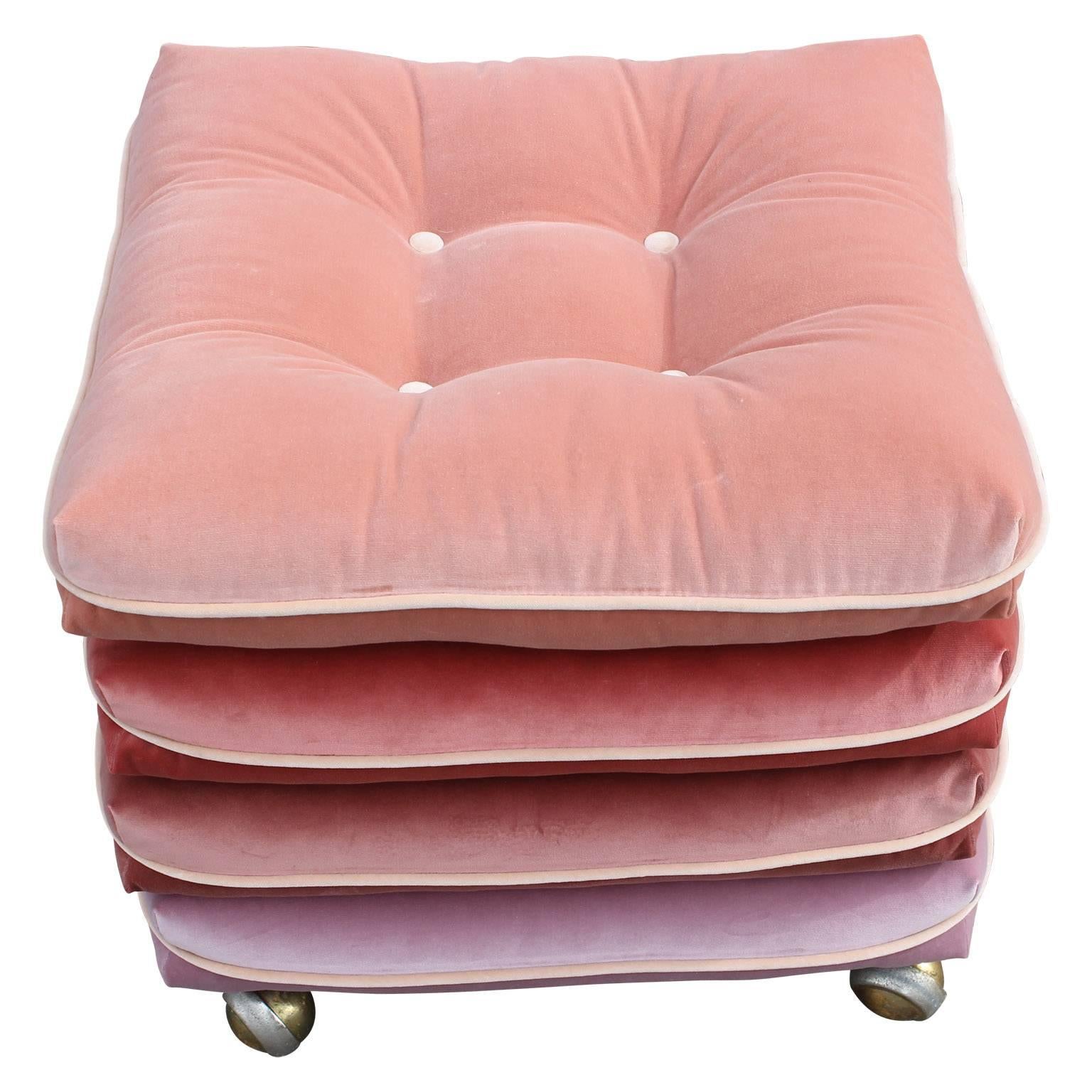 Unique and stunning pair of custom made pink velvet gradient cushion stools on rolling brass feet. The cushions are permanently attached to the base. These would be perfect for any modern, mid-mod or hollywood regency space. 