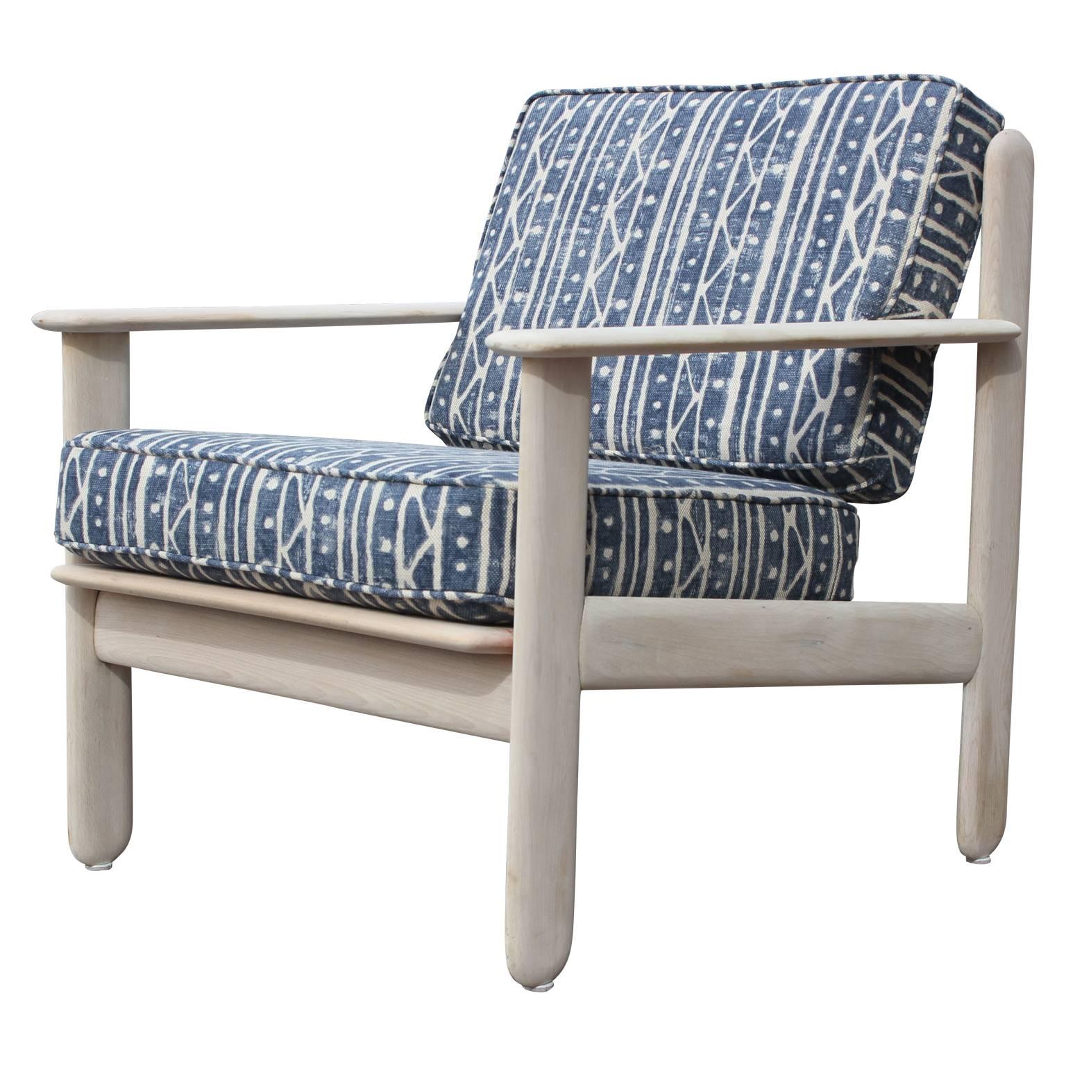 Pair of modern bleached wood Italian lounge chairs freshly upholstered in a nice indigo blue and white patterned heavy linen called Indican by Kravet. The pattern has even been expertly matched on the cushions and piping.  