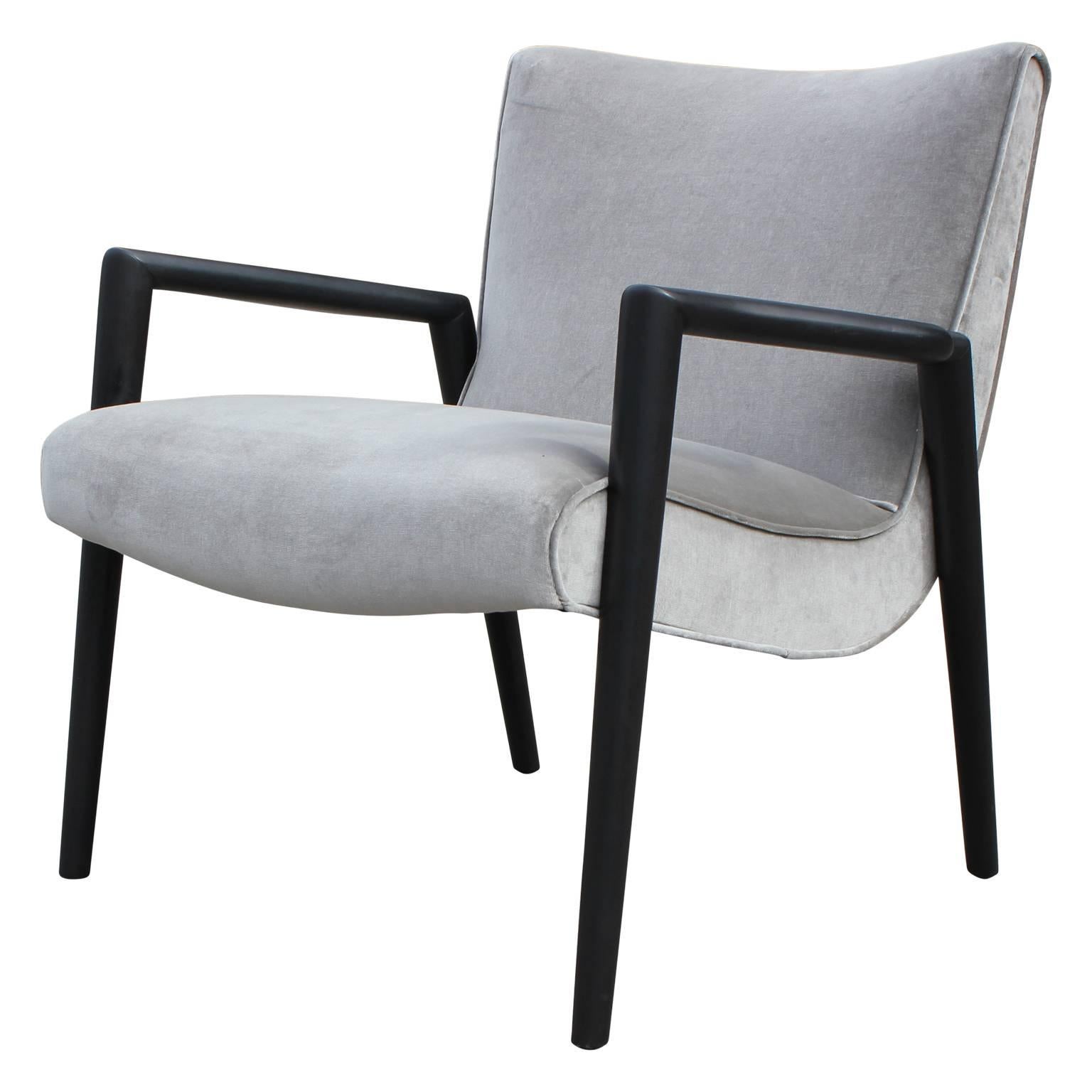 Pair of gorgeous lounge chairs in the style of Paul McCobb or Widdicomb. These have been freshly upholstered in a nice silver grey velvet and stained in a nice charcoal. Perfect addition to any mod or mid-mod space.