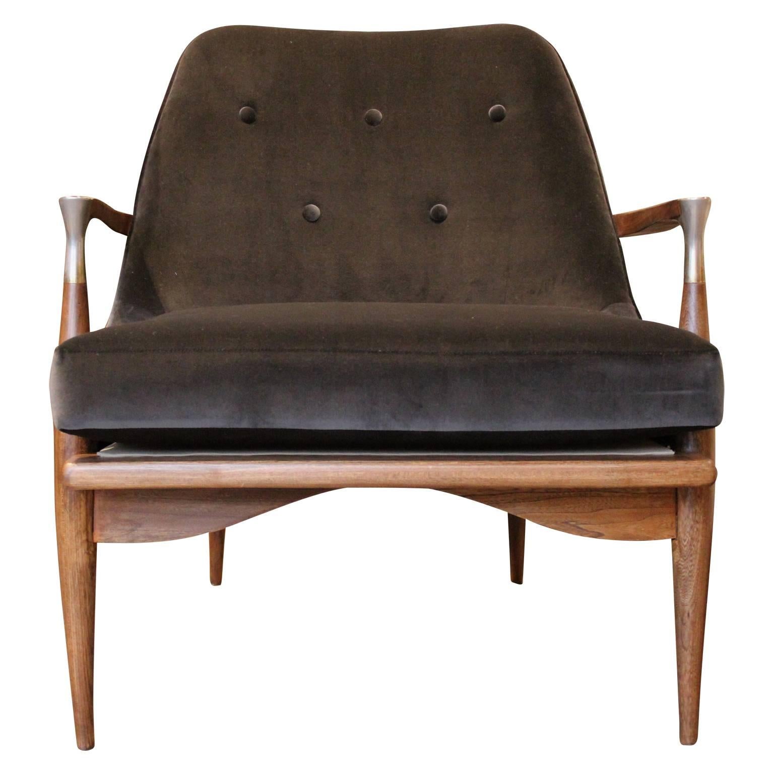 Gorgeous modern Danish style lounge chair with a walnut finish and freshly upholstered in a lush dark grey velvet. In the style of Kofod-Larsen. The walnut has a beautiful and vibrant grain. Perfect for any modern or mid-mod space.