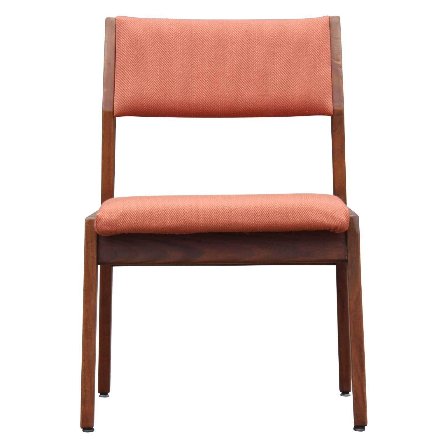 Set of four modern dining chairs by Jens Risom in the original peach / orange fabric. The sculptural design provides a nice modern and sleek look.
