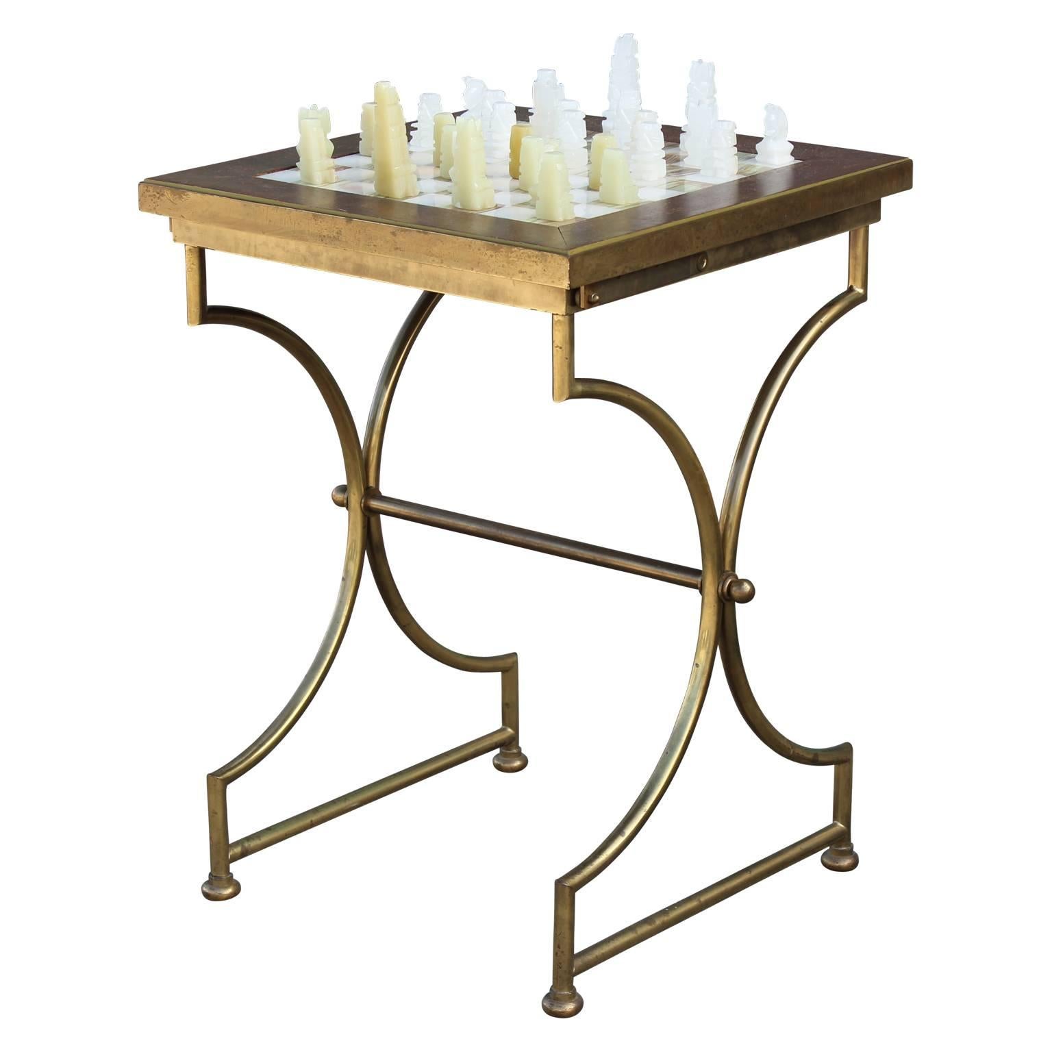 Gorgeous onyx chess table on a lovely brass base and includes a lovely onyx chess set. The table is also adjustable. A fine example of interactive art, as the chess pieces have been expertly sculpted.  Perfect addition to any mod, mid-mod or