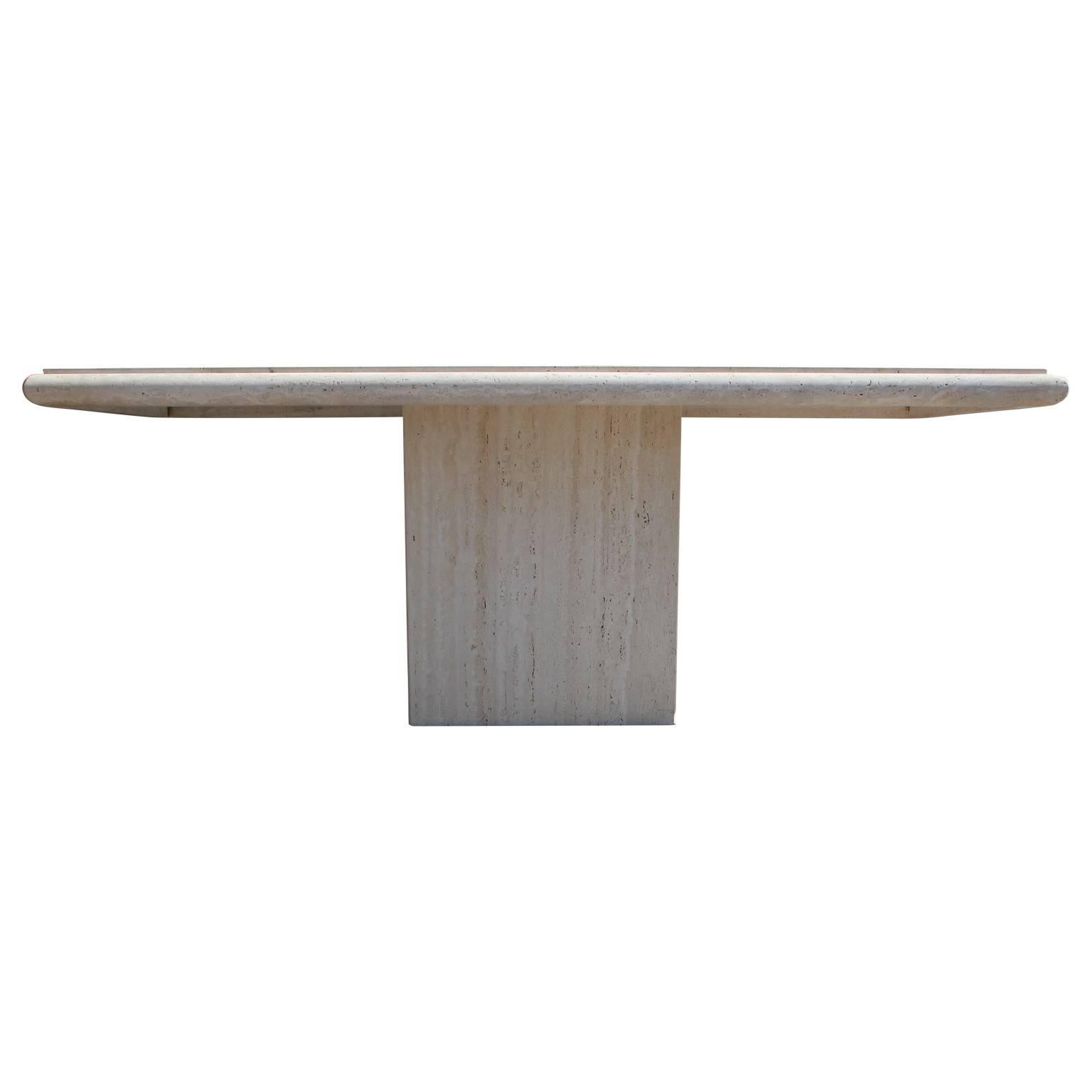 Gorgeous rectangular travertine dining table that sits on a lovely travertine pedestal.  The table top has beveled edges providing a lovely and subtle detail. Gorgeous for any mod, mid-mod or Hollywood Regency home.