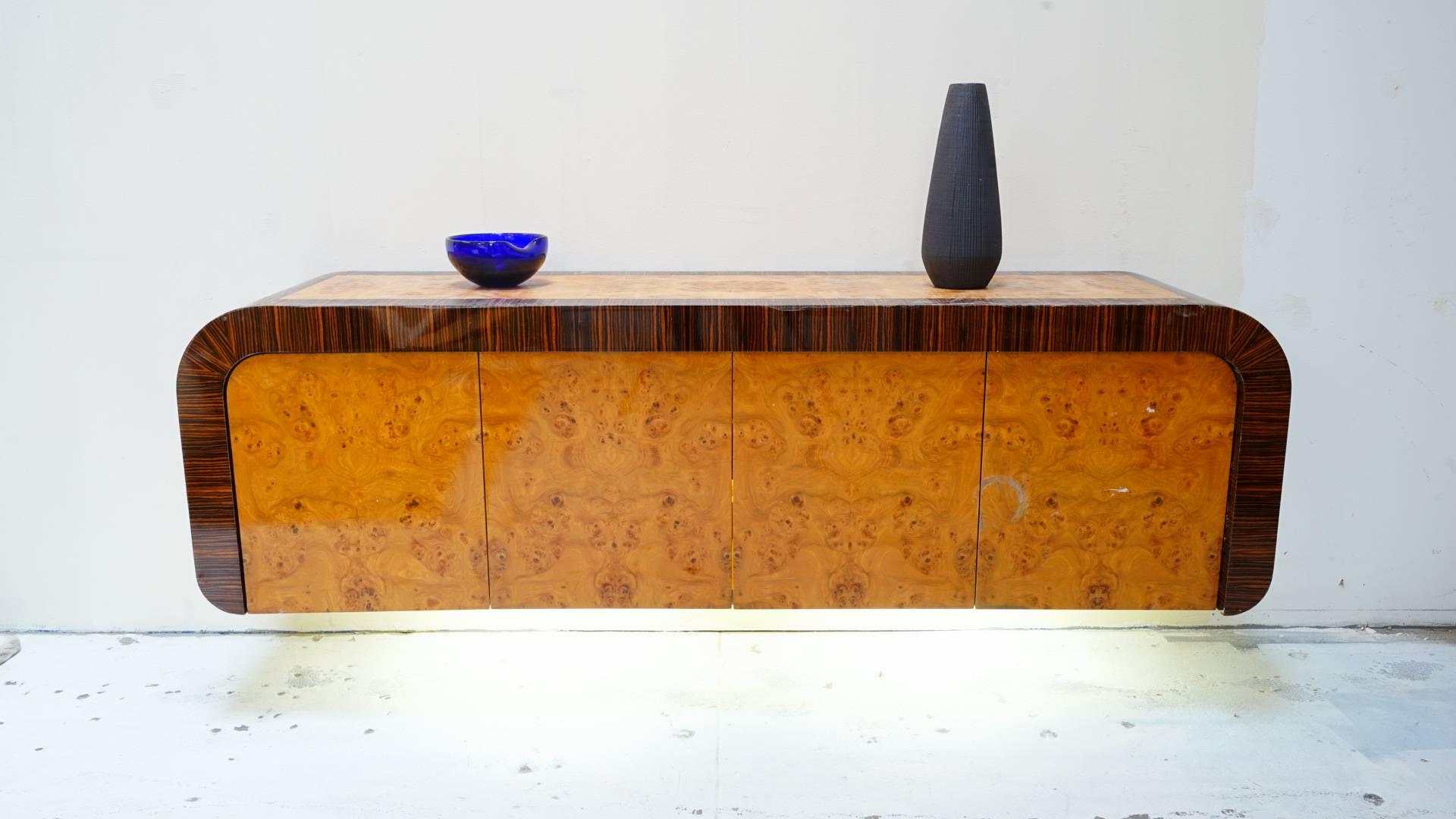 Absolutely stunning floating credenza made with rosewood and burl wood. The inside has lighting that shines on inner bottom shelving, also shines through underneath the credenza.