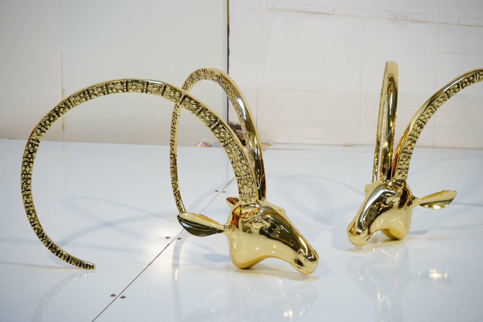 Newly polished and coated with new brass, pair of 24-karat ibex heads brass coffee table with 3/4