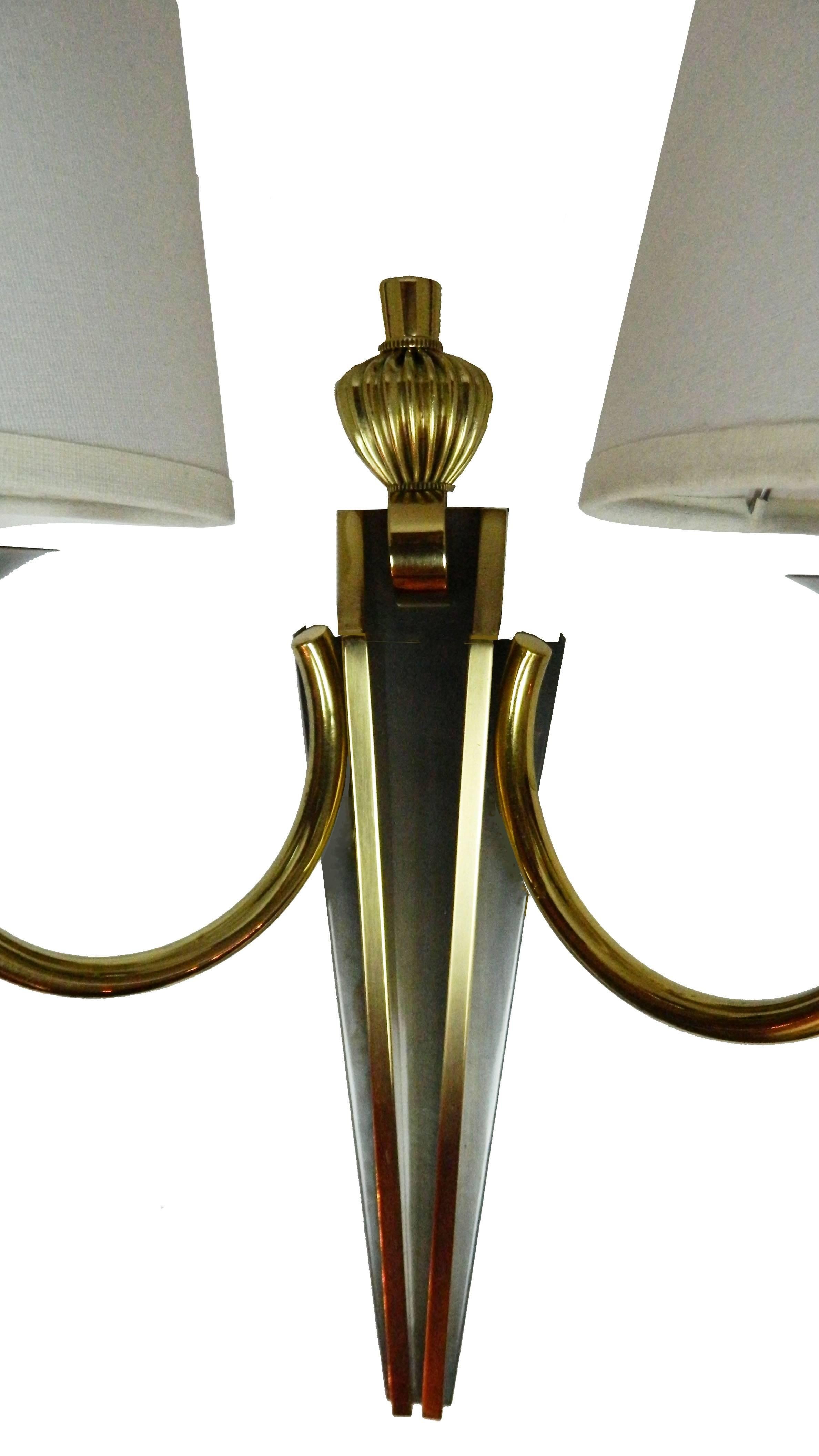 Superb two-tone brass and gun metal pair of sconces by Maison Jansen.
US rewired and in working condition.
Two bulb of 75 watts max.
Custom back plate available, ask for a quote.
Two pairs available (Four sconces).
Priced by pair.
Have a look