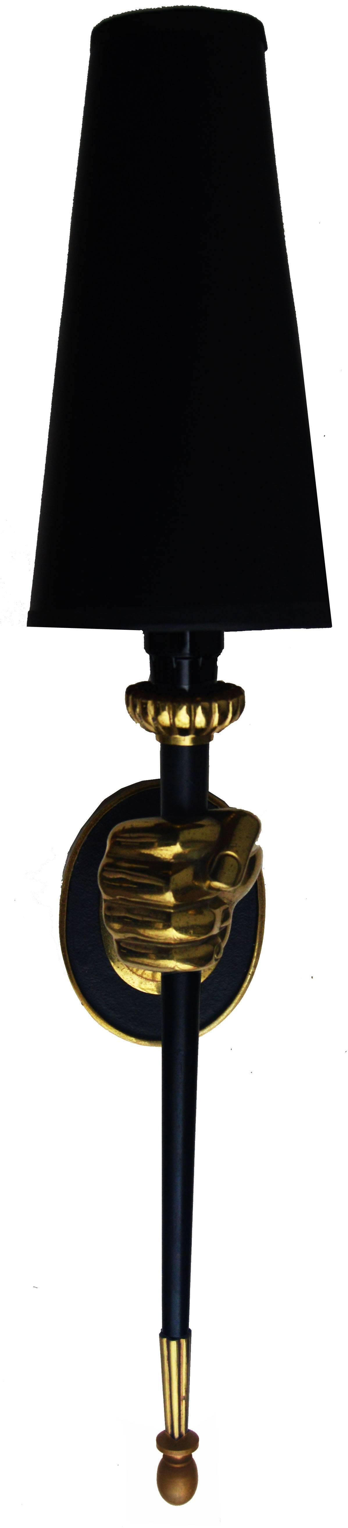 Impressive pair of sconces by Maison Jansen figuring a bronze hand holding a
black lacquered torch.
One light, 60 watts max.
US rewired.

Dimension without shade: 13 H, 3 1/4 W, 6 Projection.
Backplate: 4.5 H , 3 1/4 W.