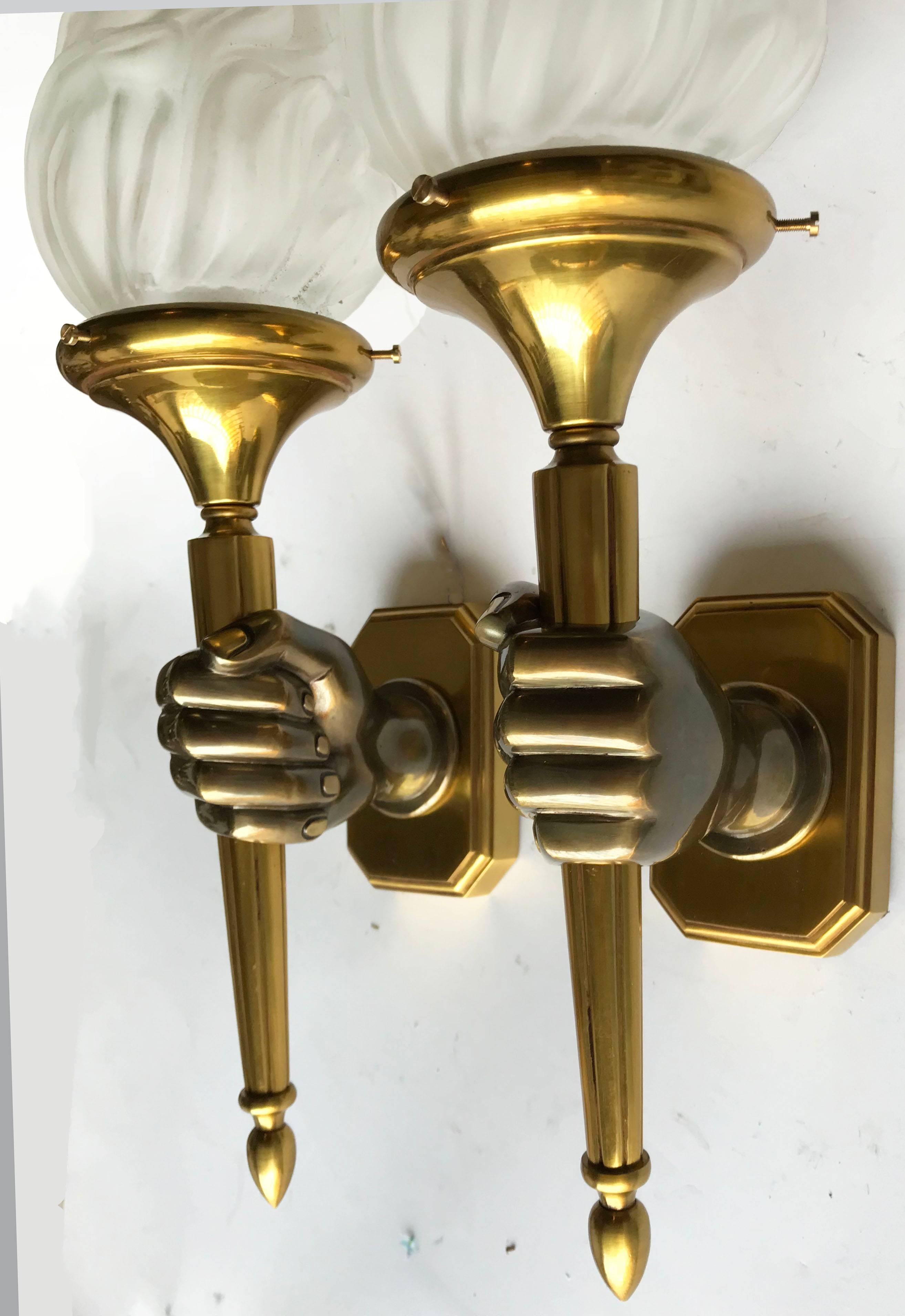 Superb pair of opposite hand sconces by Maison Baguès, figuring a hand holding a torche.
Two patina bronze
One light, 65 watts max bulb
Back plate: 4.25 inches height, 2.75 inches wide 
Priced by pair
