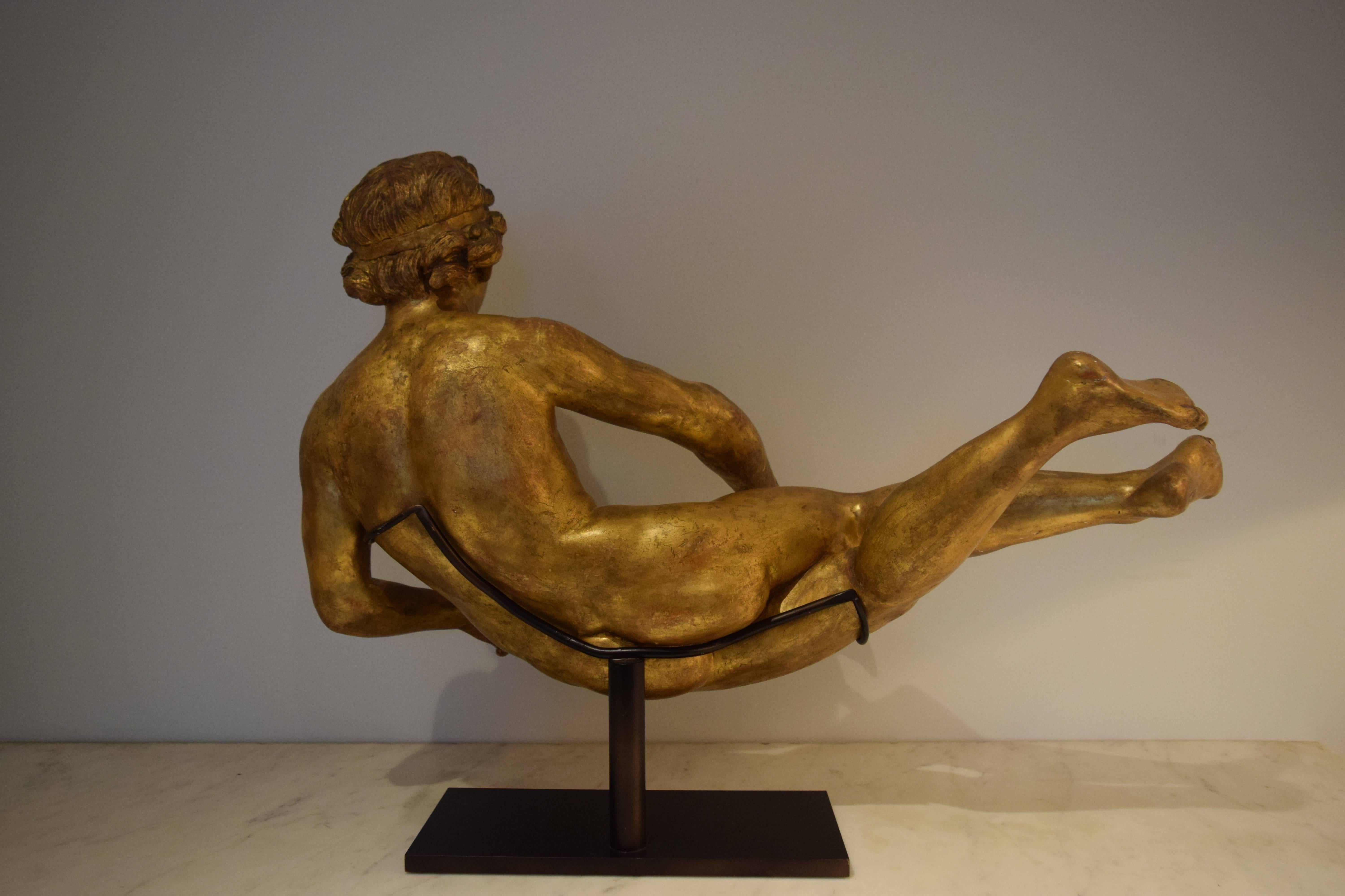 This giltwood sculpture was carved in the round, probably in southern France or northern Italy in the 1760s.  Her pronounced musculature speaks to the ongoing influence of Michelangelo.  On the modern bronze stand the sculpture is 18" high,