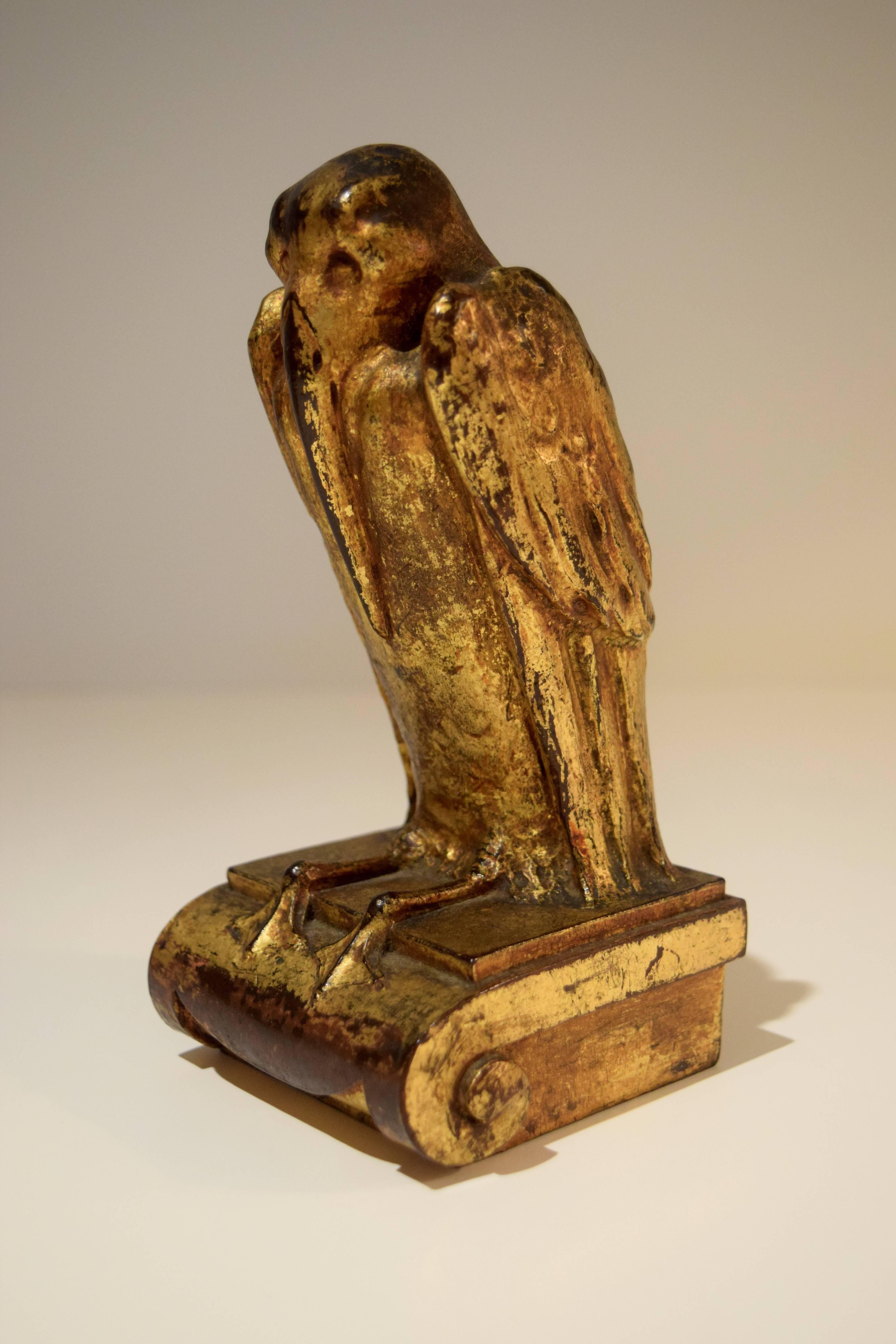 The unknown sculptor of this fine, gilded-mahogany pelican appears to have been influenced by the turn-of-the-century Symbolist movement in Europe. The breast feathers are subtly carved, and the webbed feet cling to an Ionic capital-inspired base.