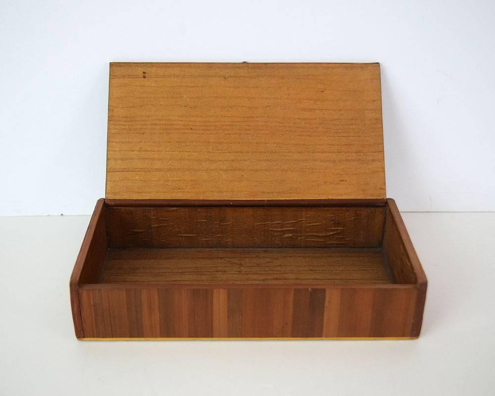 This large French straw-marquetry box, dating from the 1930s, may have been retailed by the Paris designer Jean-Michel Frank. The interior is lined with thin wood veneer and the top is secured by two metal pins and a metal clasp.