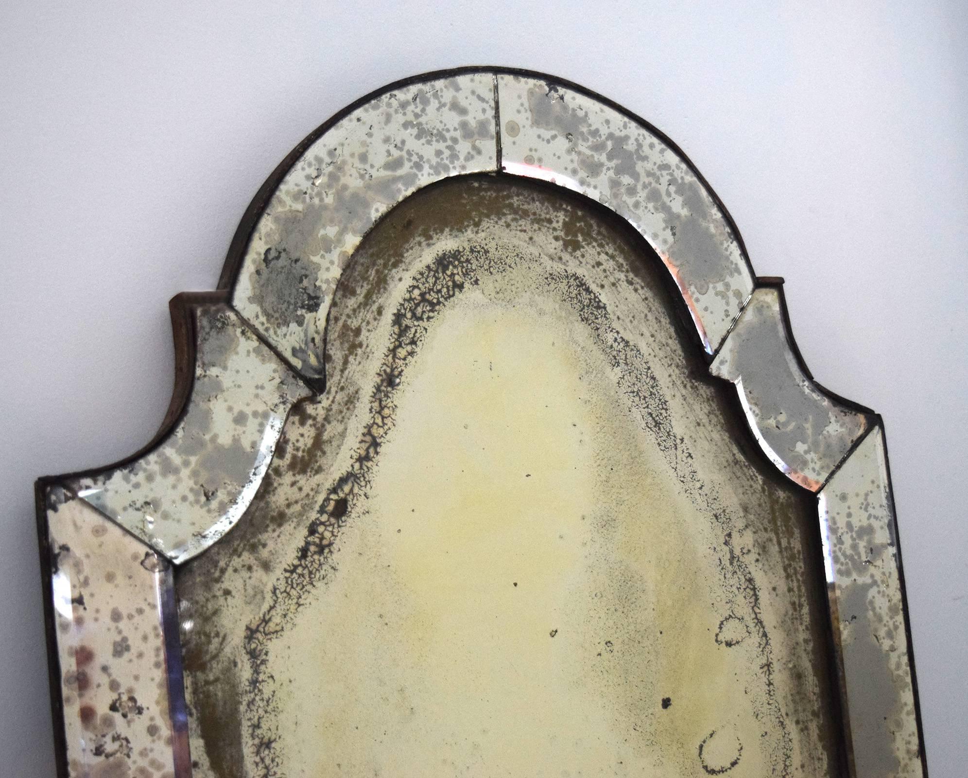 This charming mirror-framed mirror dates to the early 18th century, is probably German or Baltic, showing the English influence among the Hanseatic League cities. All of the original mirror plates have miraculously survived, and acquired a lovely