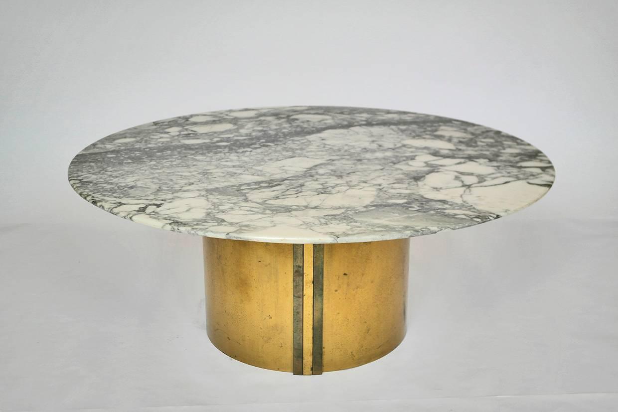 An unusual veined marble and brass composite occasion table, the base is comprised of brass wrapped around a wooden hollow form. Marble top is not fixed to base.
    