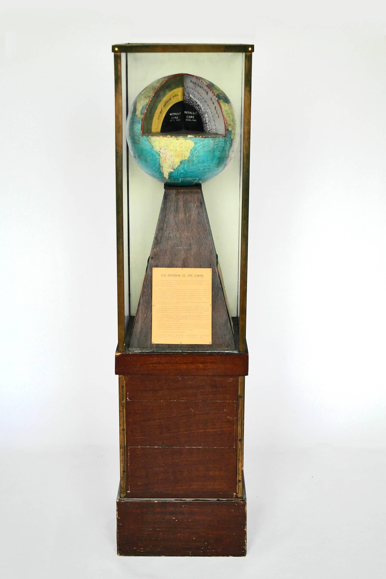 A interesting educational model of the structure of the earth encased in a mahogany and glass cabinet.