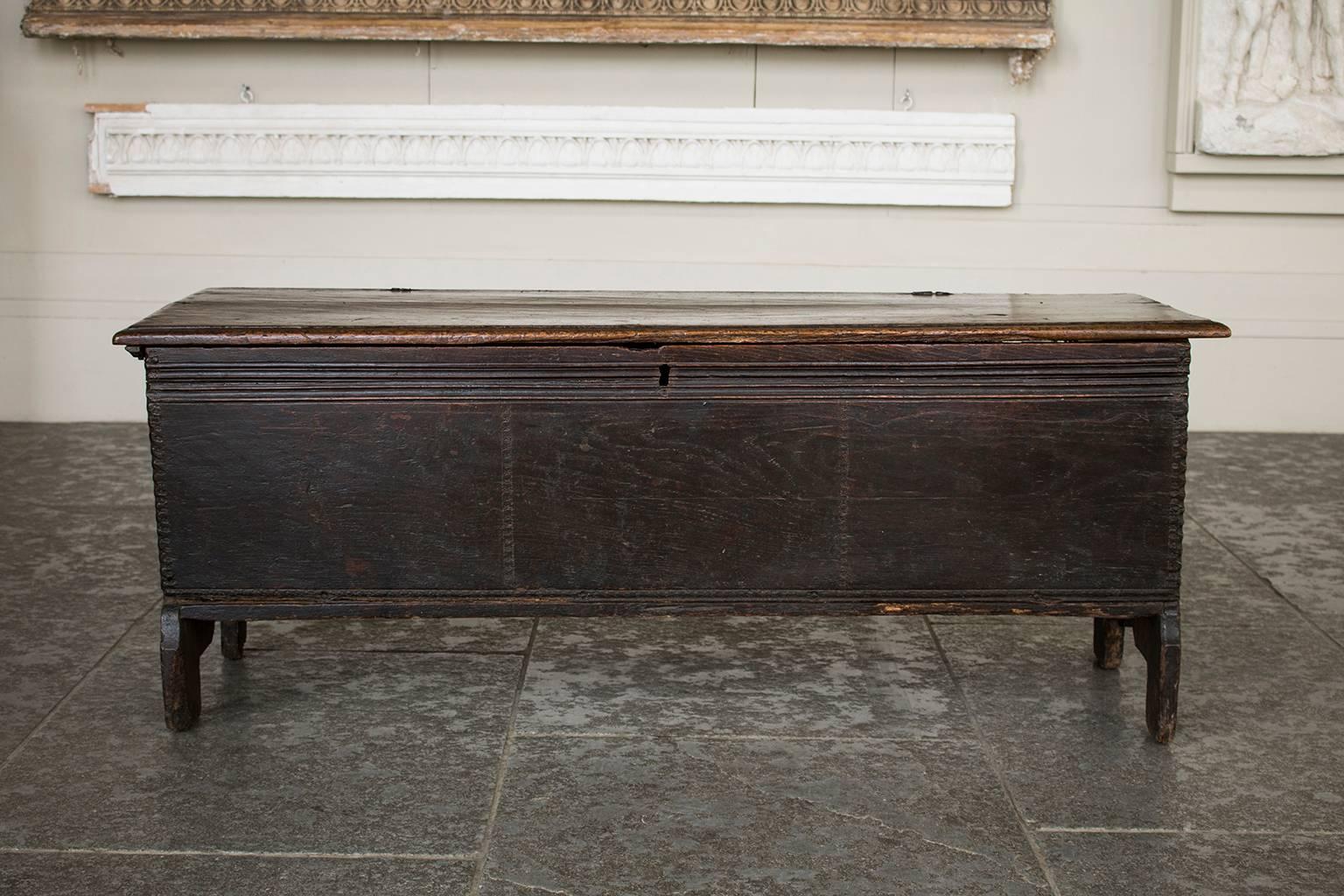 Dark oak 17th century coffer or blanket box with hinged plank top.