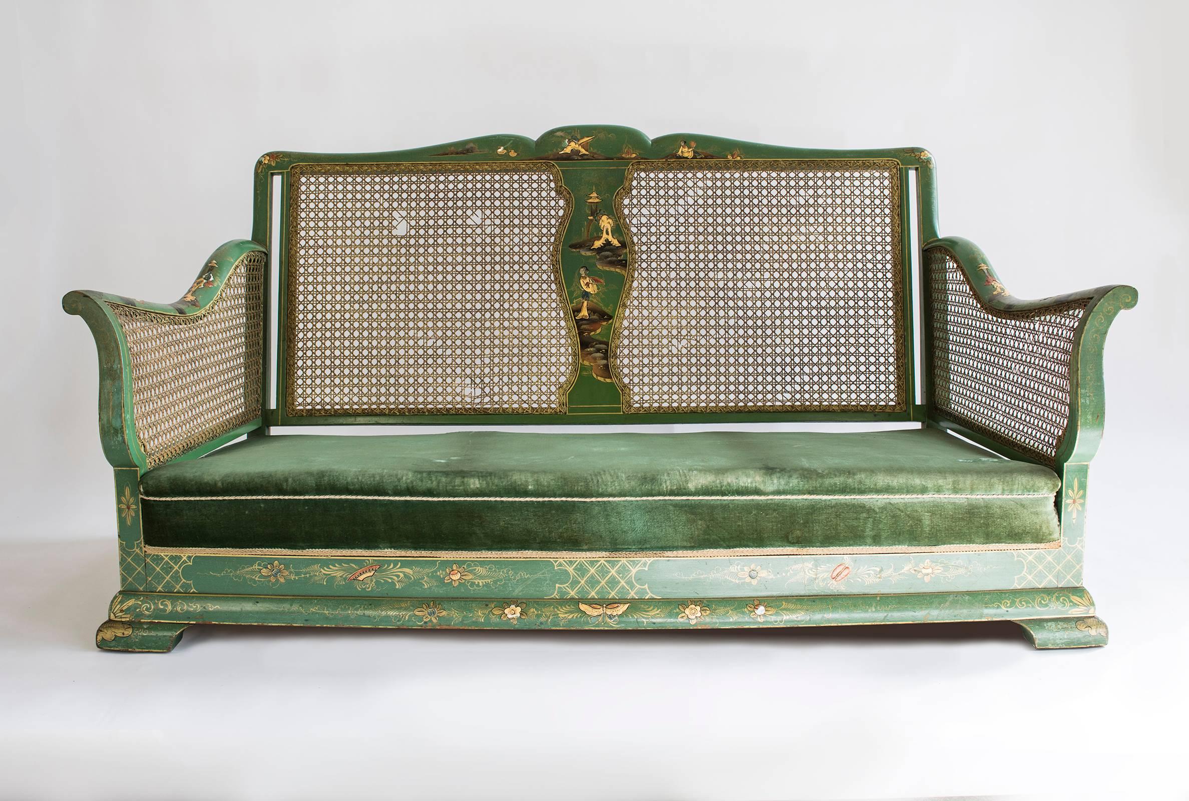 An early 20th century green chinoiserie lacquered bergère suite, comprising three-seat sofa and a pair of armchairs, the raised decoration heightened in gilt, with cane inset panels,

Measure: Armchairs 85 x 72 x 72 cm
Sofa 165 x 86 x 80 cm.