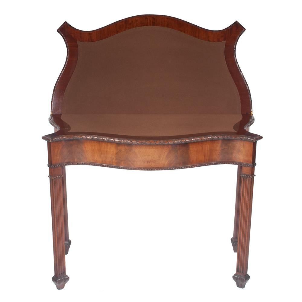 Chippendale mahogany serpentine shape lift top game table with gadroon carved top on fluted legs with Marlboro feet, circa 1880. This table features a drawer on one end for storage, as well as beautiful hand carving around top and fluted legs.