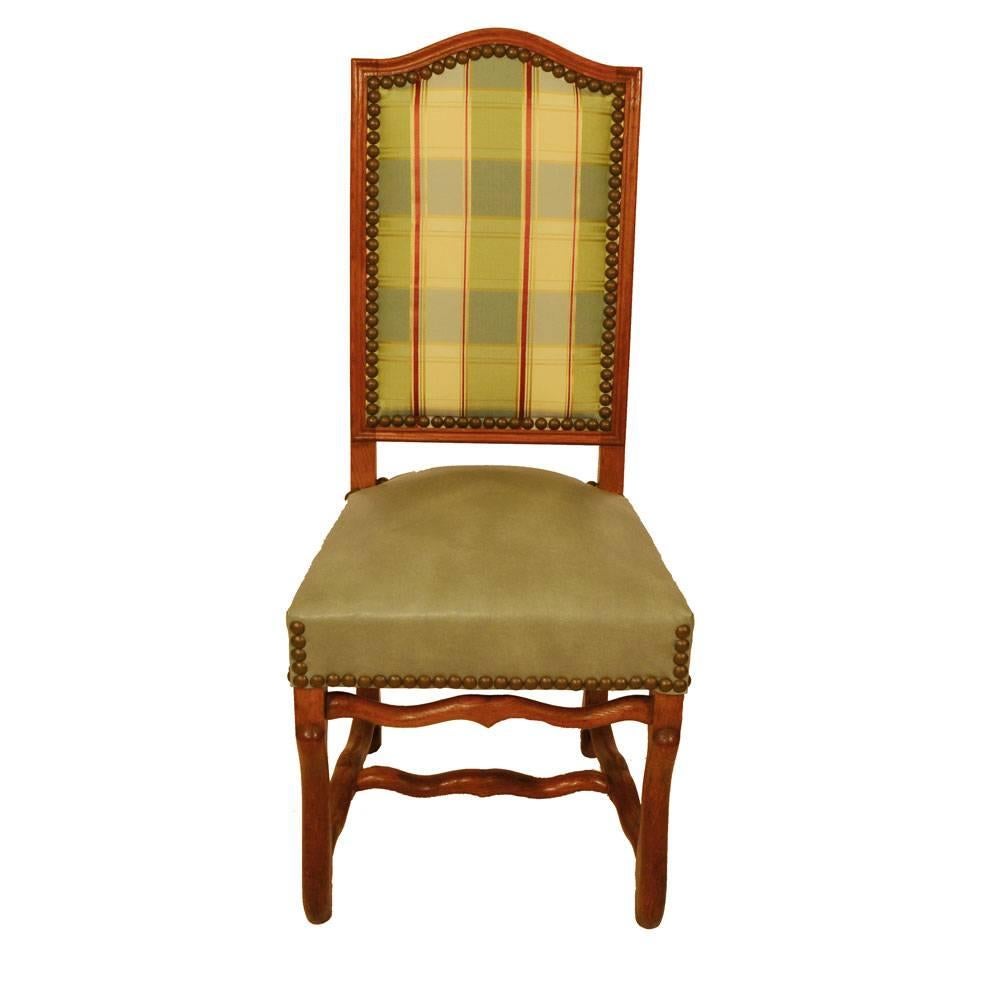 Set of eight, circa 1920 French country elm dining chairs with arched backs, cabriole legs and shaped stretchers. Chairs feature large antique brass nailhead trim. Seat, measures: 19.5