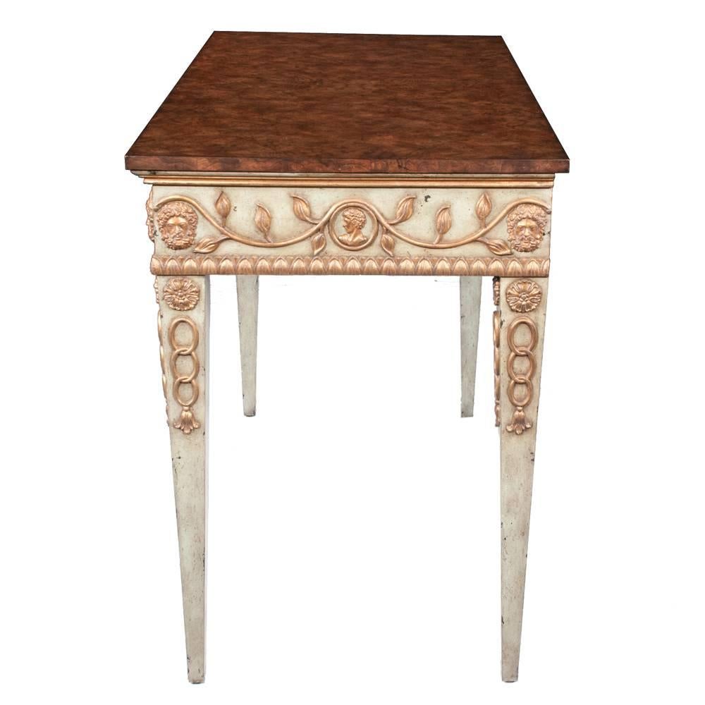 Louis XVI style decorated console table by Maitland Smith featuring a burled walnut top, gold gilt raised hand-carved decoration on the apron and top of the legs.