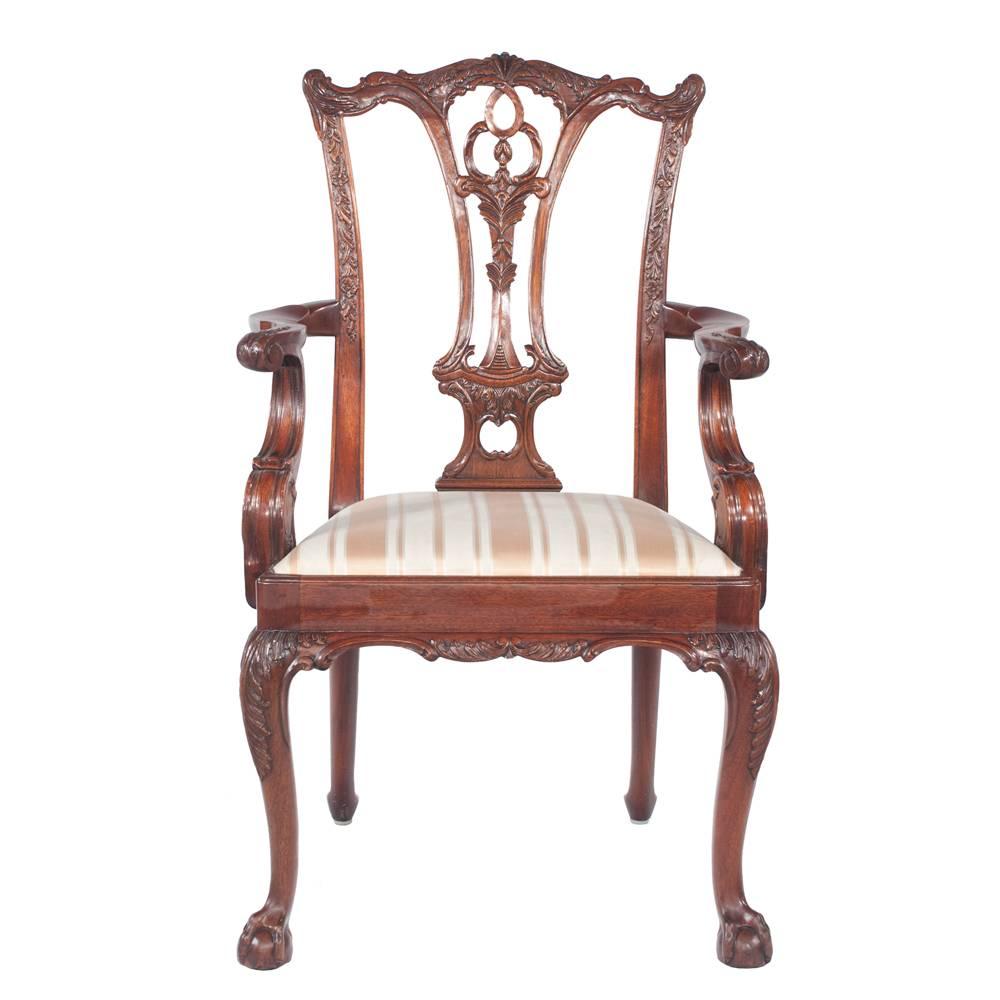 Set of eight Chippendale style mahogany dining chairs with carved backs, on cabriole legs featuring carved knees and ball and claw feet. Armchairs 24