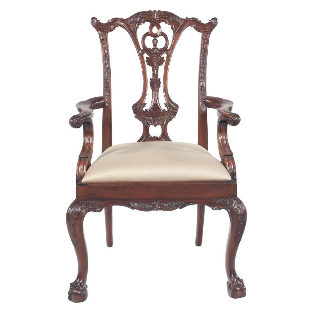 Set of ten solid mahogany dining chairs by Maitland-Smith. Chairs have pierced, carved backs, carved cabriole legs and ball and claw feet. Seats are cream upholstered in a sateen fabric, neutral. 
Dimensions: Armchairs are 27