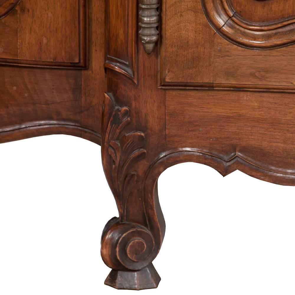 Solid walnut Country French buffet with most unique rounded corners with drawers as well as doors being rounded. Five drawers and five intricately carved doors below offer generous storage for silver, linens and chinaware. All antique brass pulls
