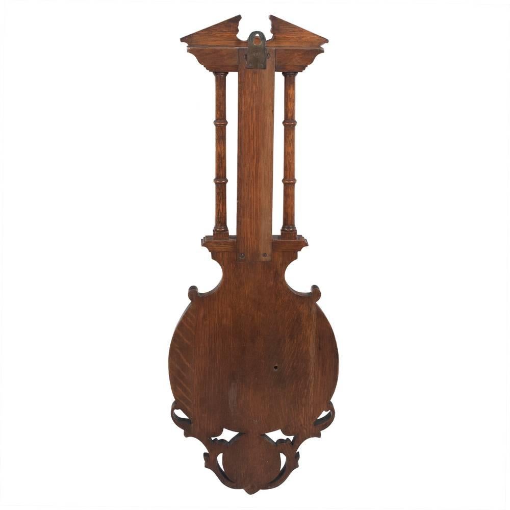 Solid oak English barometer with architectural pediment and shell carving at the base...signed J. Hall, Bradford, circa 1900.