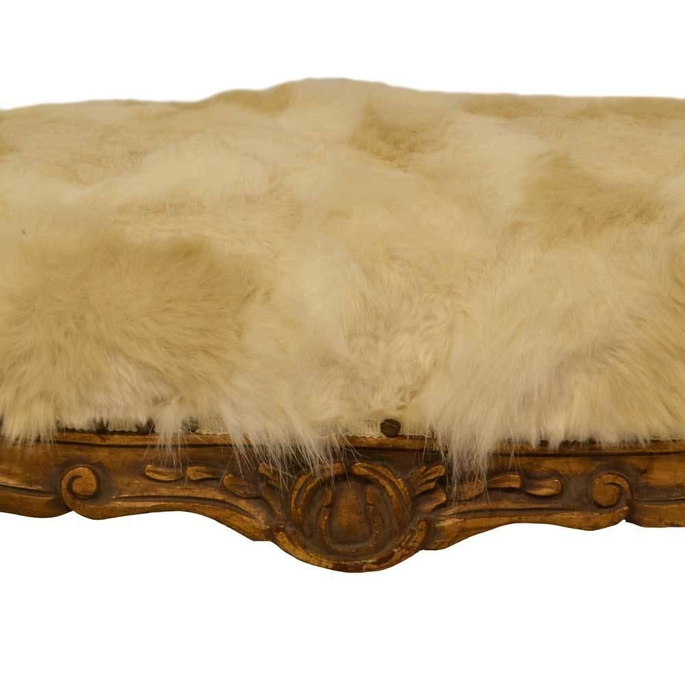 French Louis XV bench featuring cabriole legs with hand-carved detail. The bench is upholstered in a cream and white faux fur, with added nailhead studs. Seat height: 22.5 inches.
 