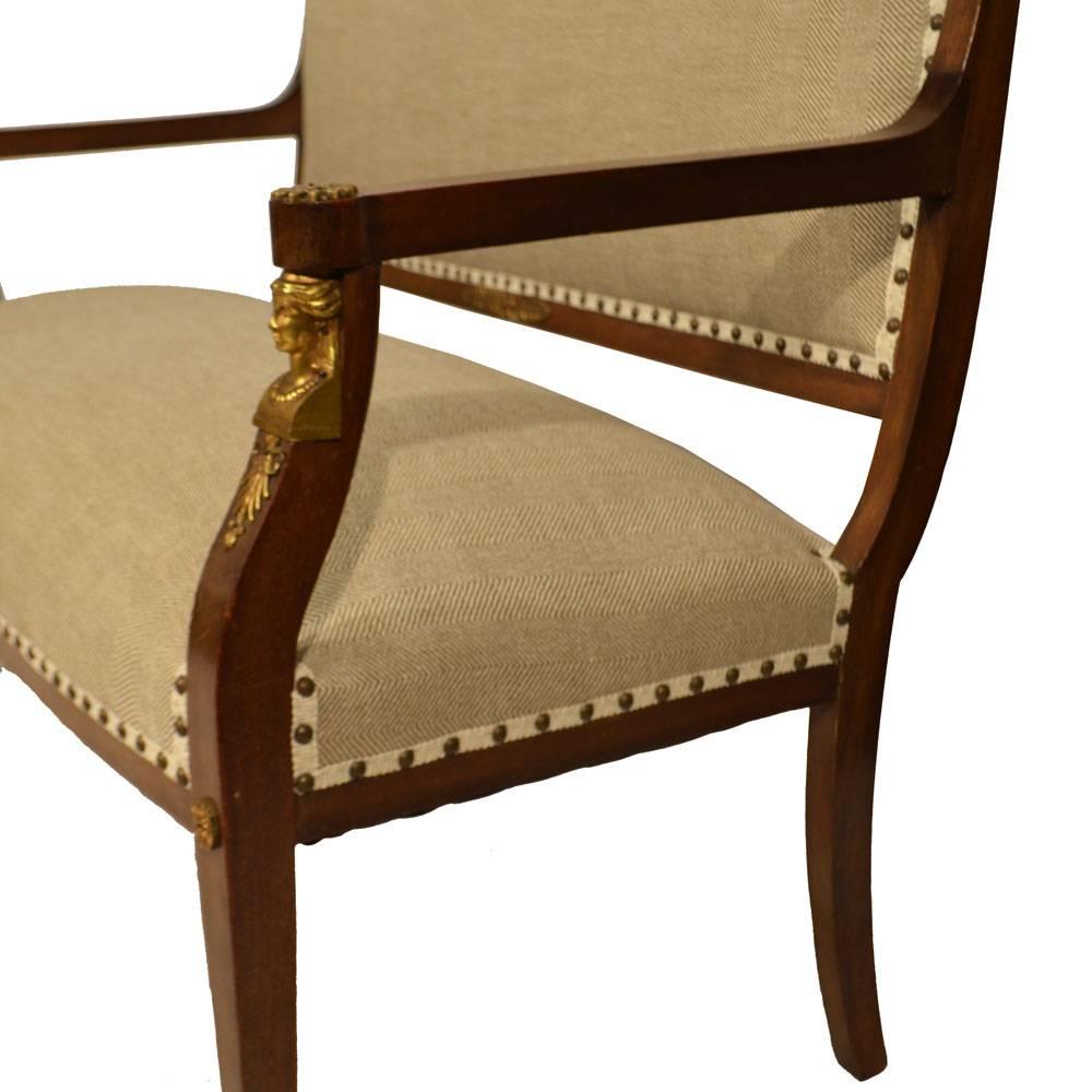 Empire style mahogany canapé with bronze mounts and on square tapered legs with bronze claw feet. This canape has been newly upholstered in a neutral heavy fabric with antique brass nailheads added for detail. Comfortable seat, sturdy legs.Seat