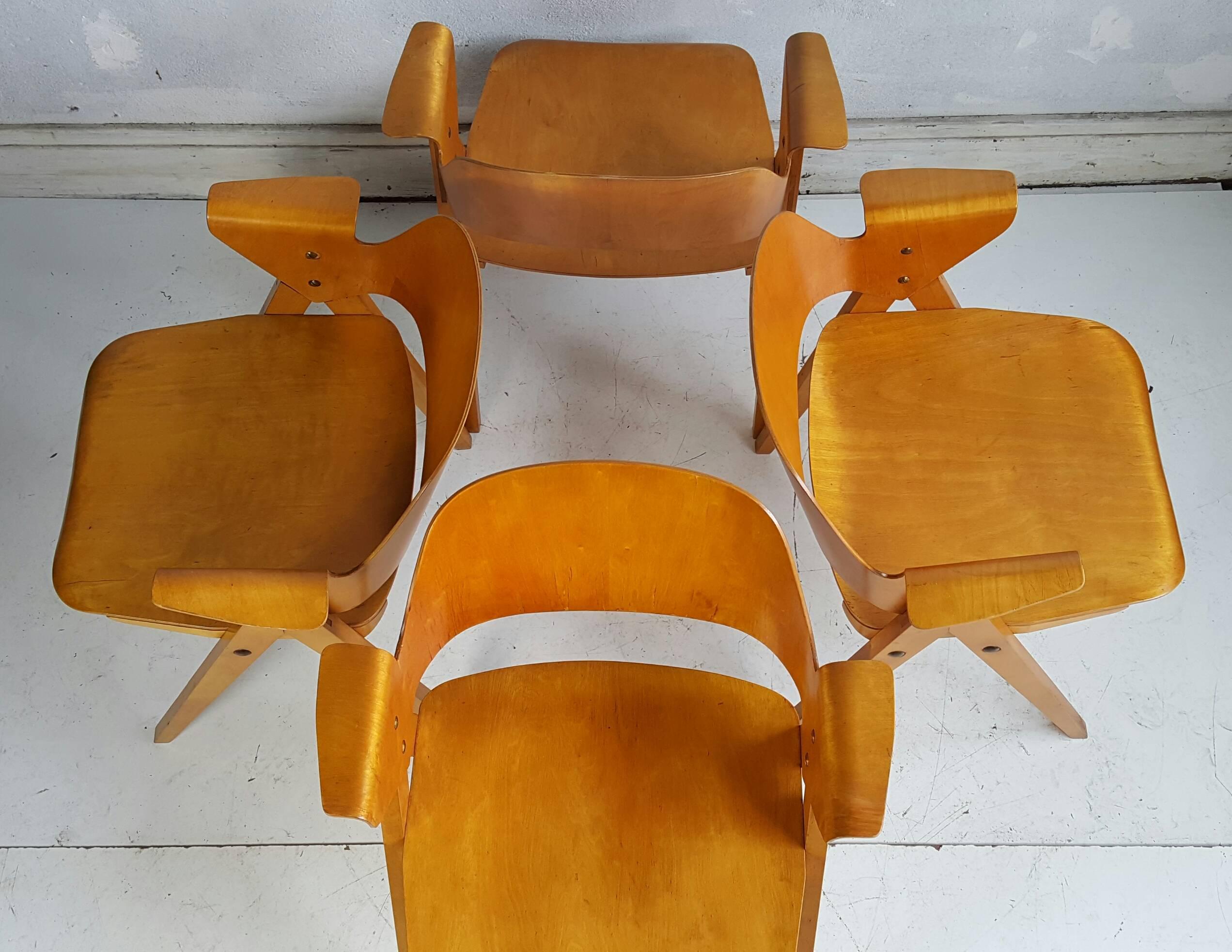Set of four bent, molded plywood armchairs designed by Elias Svedberg for Nordiska Konipaniet, Sweden. Classic Eames-like styling. Extremely rare, made in limited numbers for only a few years.