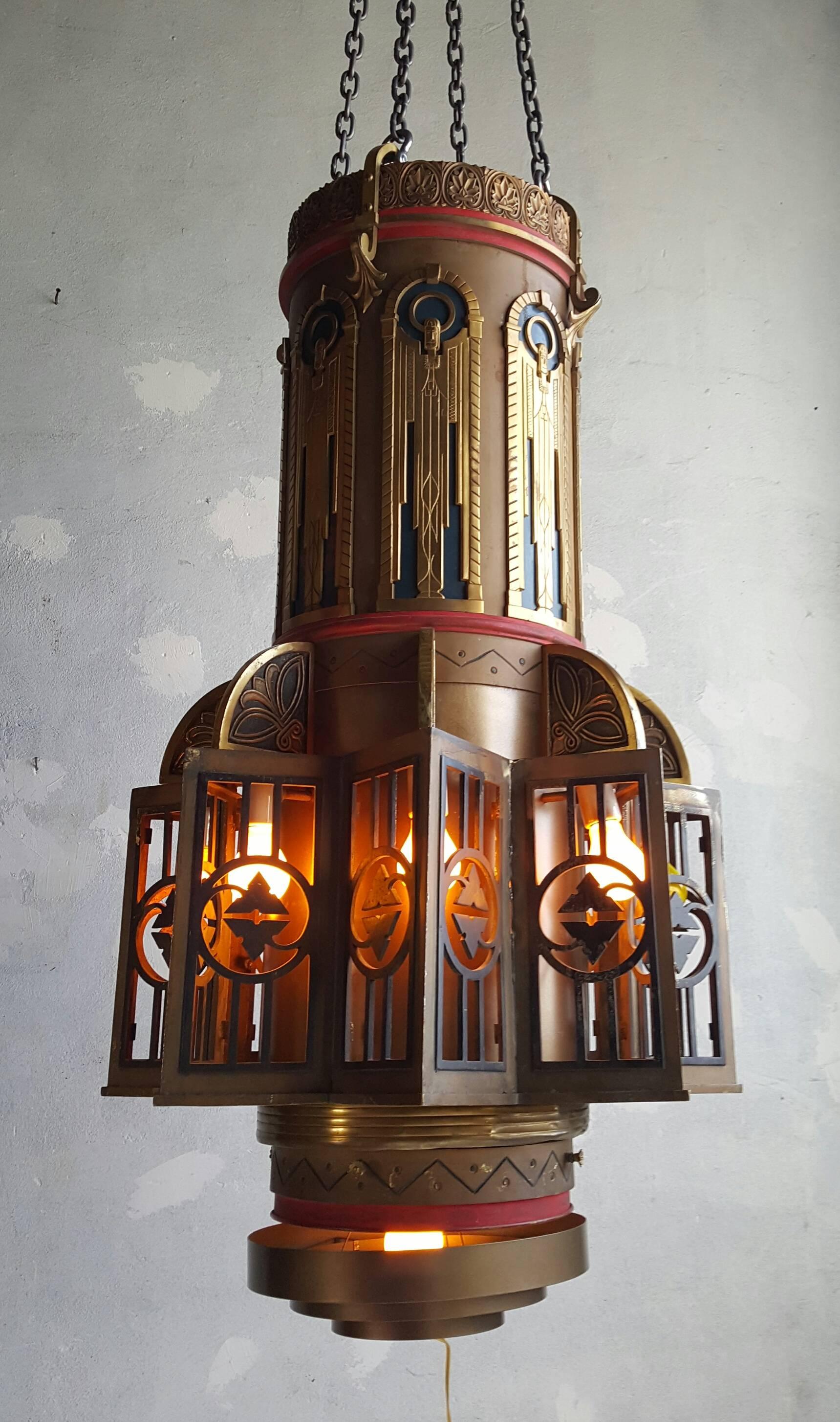 Outstanding pair of Art Deco hanging pendant / chandeliers. Salvaged from 1930s theater. Bronze and iron construction, stylized angel motif, custom glass panels will (can) be added if desired. Retains original decorative canopies, fully restored,