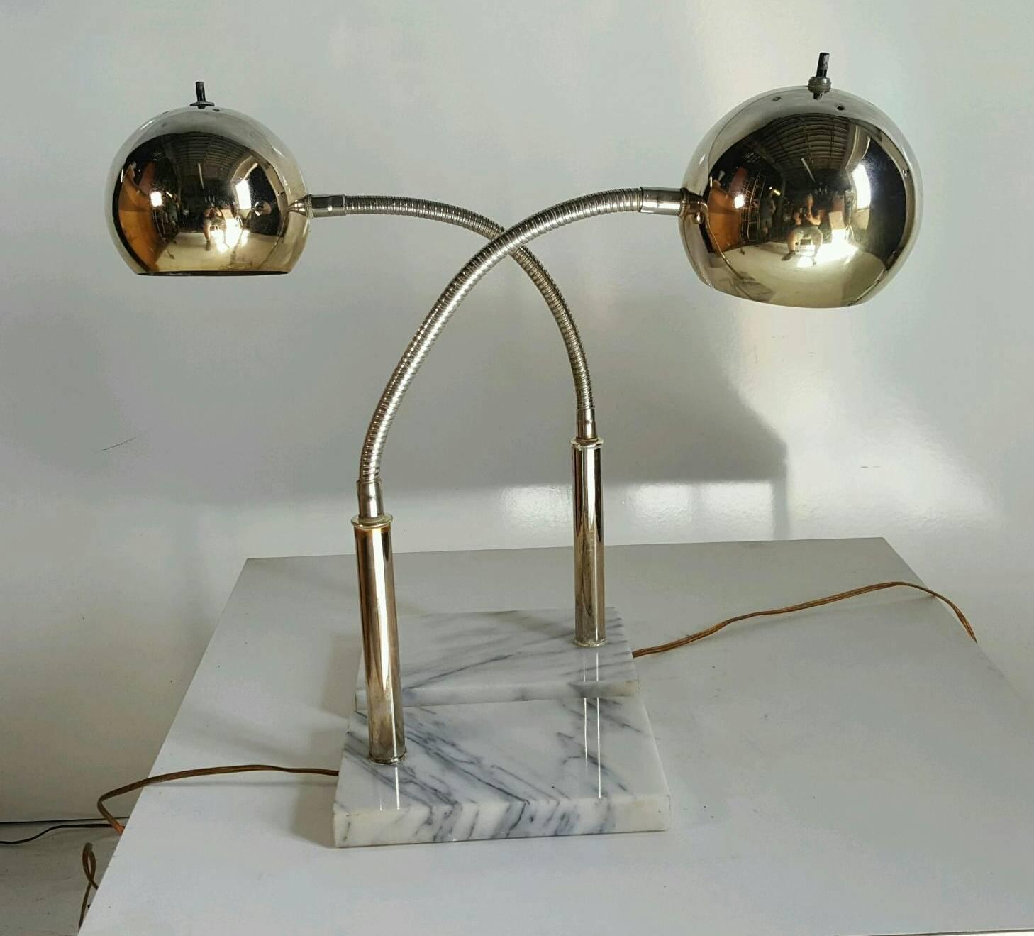 Stunning pair of modernist eyeball adjustable table lamps. White Carrara marble bases, chrome standards, flex steel bendable fitters, Classic eyeball sphere shades, chrome has brass hue. Bases measure 9