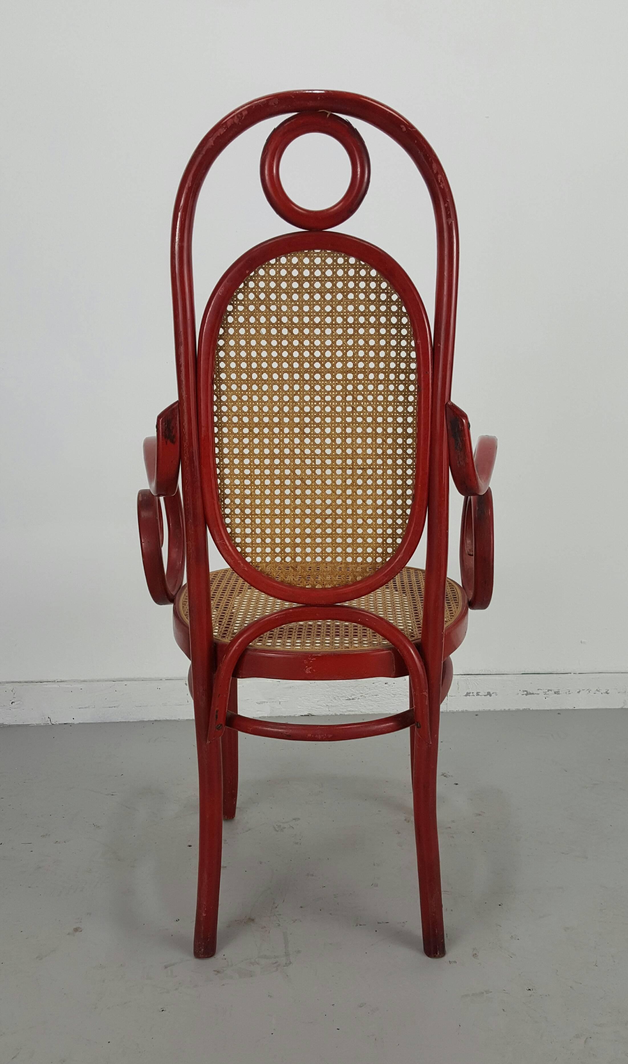 This model 17, bentwood side chair with a cane seat and back was designed by Michael Thonet for his own company in the 1860s. This example was produced in the 1970s and is in a very good and untouched vintage condition. Retains original red aniline