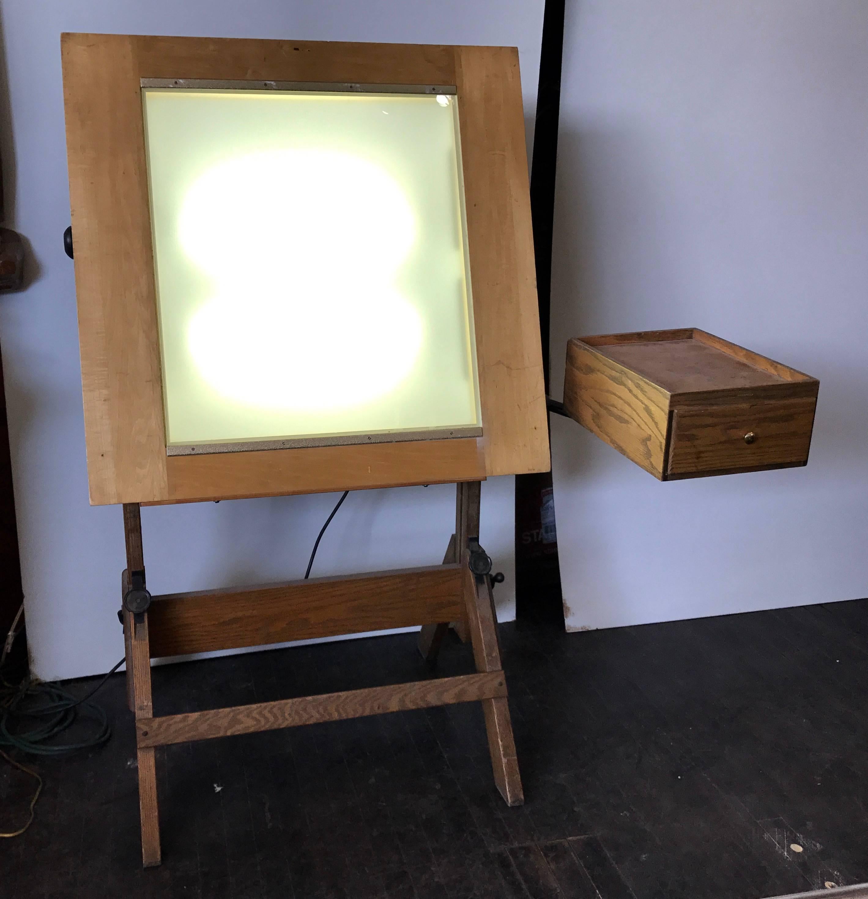 This vintage Hamilton drafting light table would be perfect tracing, opaquing, stripping, transparency, and slide viewing. The angle of the tabletop and the height of the desk are easily adjustable as well as the pivoting top, elusive swing out