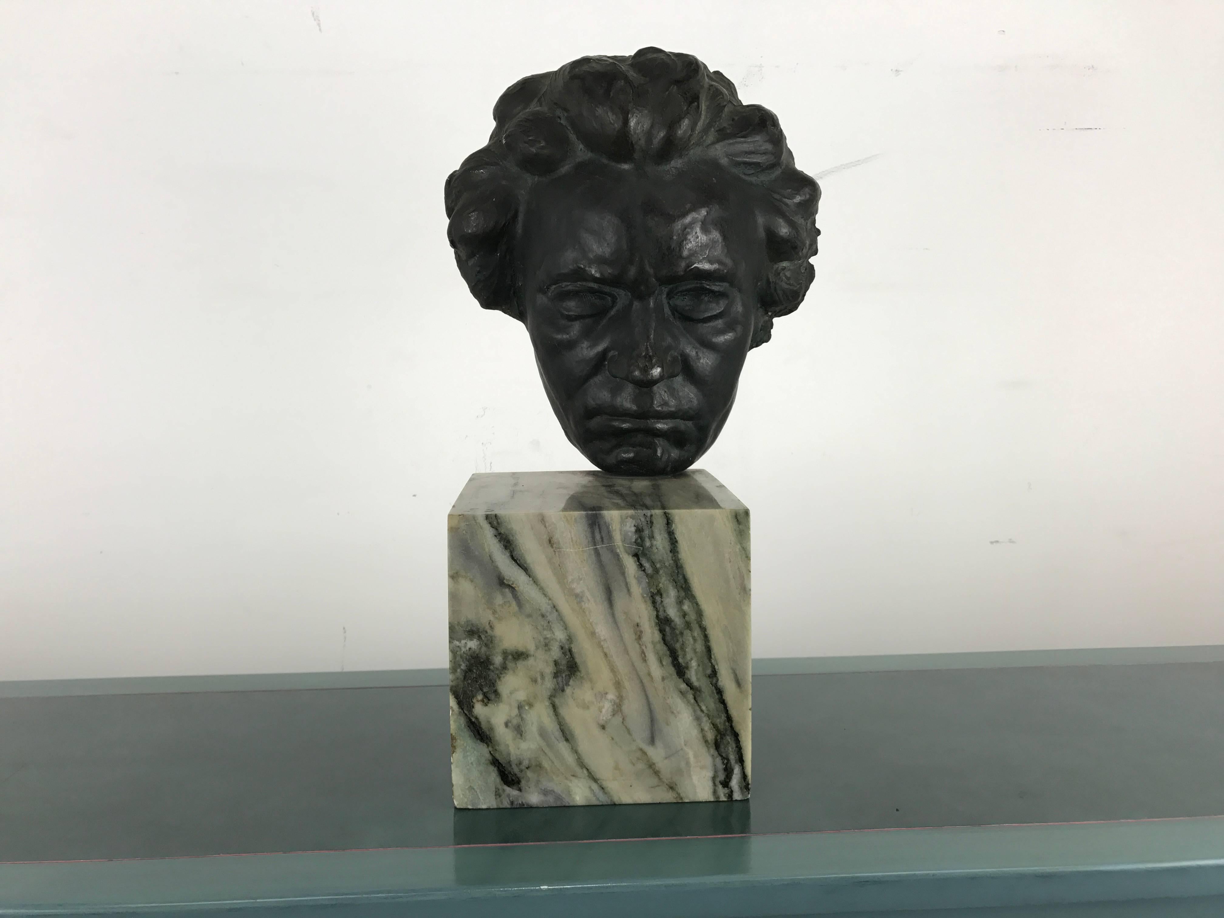 Bronze and marble head of Beethoven sculpture.

Unusual off centre placement of bronze head onto marble base, with a well-balanced result in both appearance and weight. 

Bronze head is a rich dark verde green mounted onto a square marble base