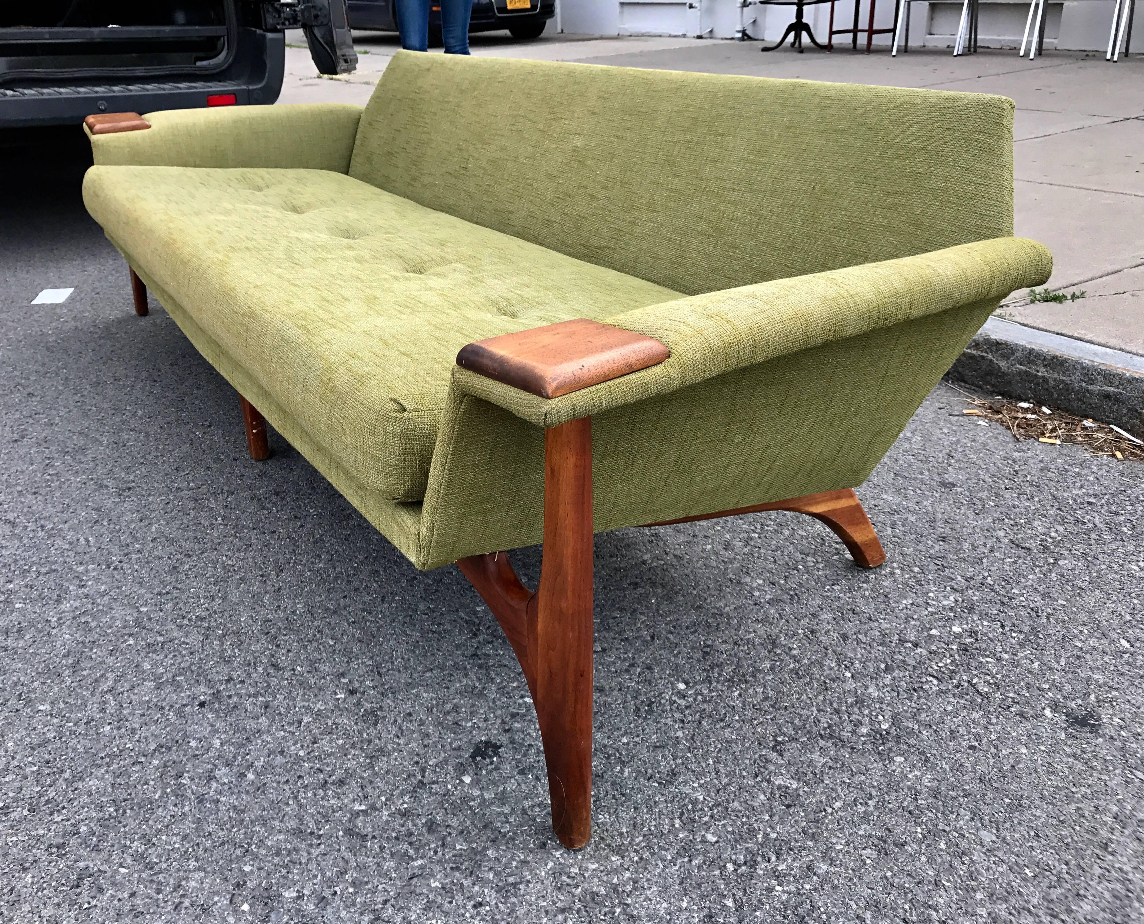 Rare and beautiful full sized sofa designed by Adrian Pearsall for his company Craft Associates, circa 1960. This highly sculptural piece is comprised of a solid walnut wood frame. Retains original fabric,
adding to the sculptural lines are Classic