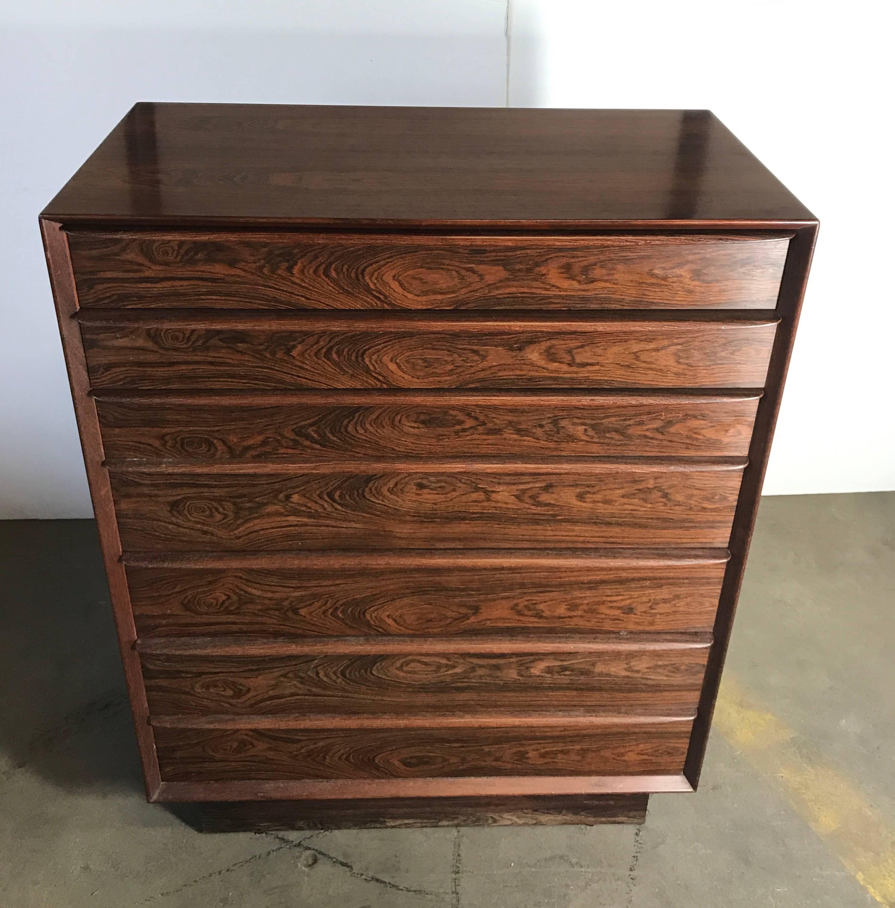 Stunning rosewood Falster seven-drawer chest made in Denmark, beautiful bookmatched grain. Superior quality and construction. Dove tail joinery, solid birch interior to drawers., rosewood finished back.