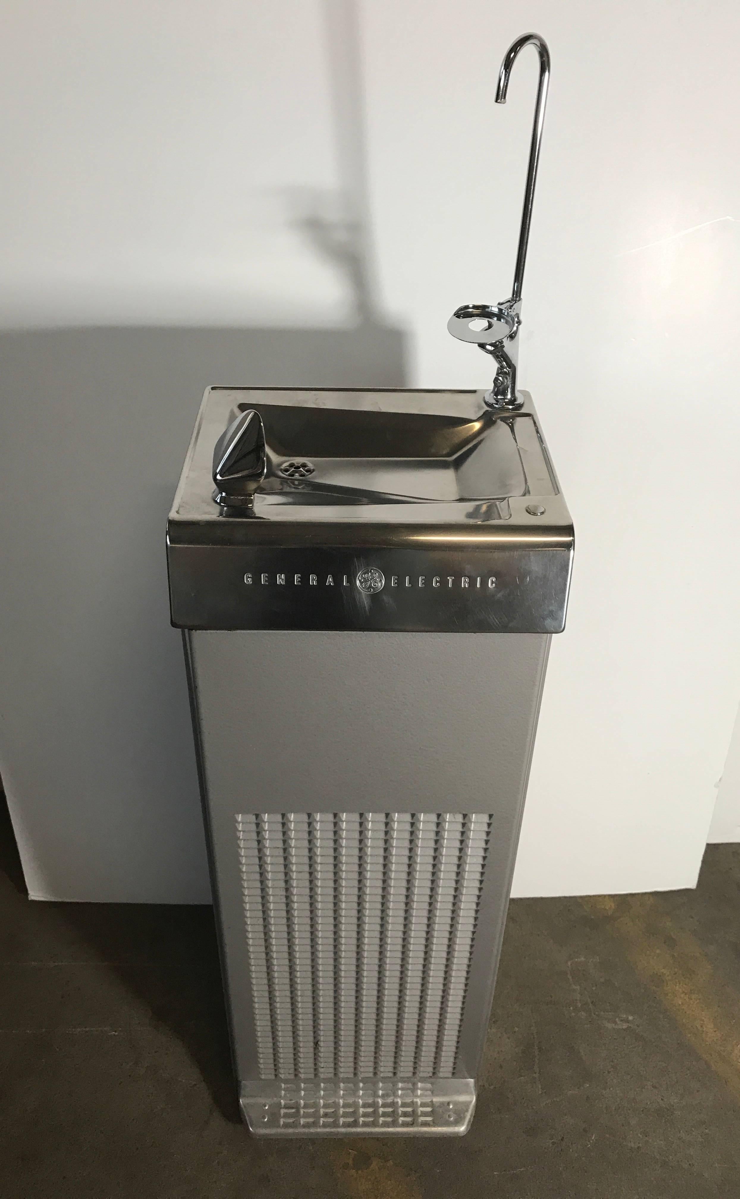 Mid-Century Modern General Electric Drinking Fountain,Amazing Modernist design,, New Old Stock,Tested and working ,Measures 41 inches high  .53 inches high with additional cup dispenser and  pourer. Hand delivery available to New York City or