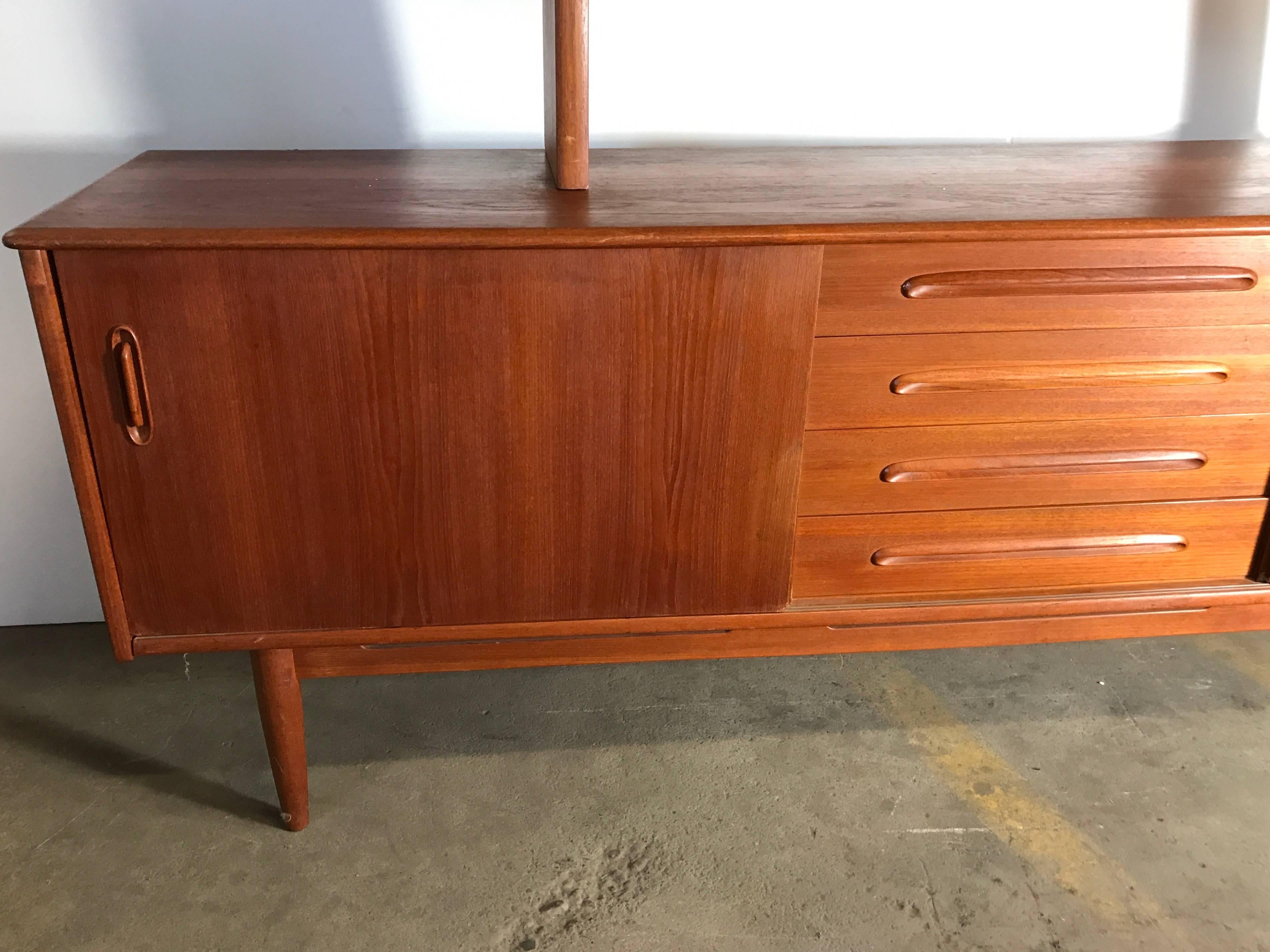 Classic Danish modern teak credenza with top after Hans Wegner, Large 88 inches wide server featuring two sliding doors. Shelves and five drawers in the centre, beautiful hand-sculpted hand pulls, floating top display with two sliding glass doors,