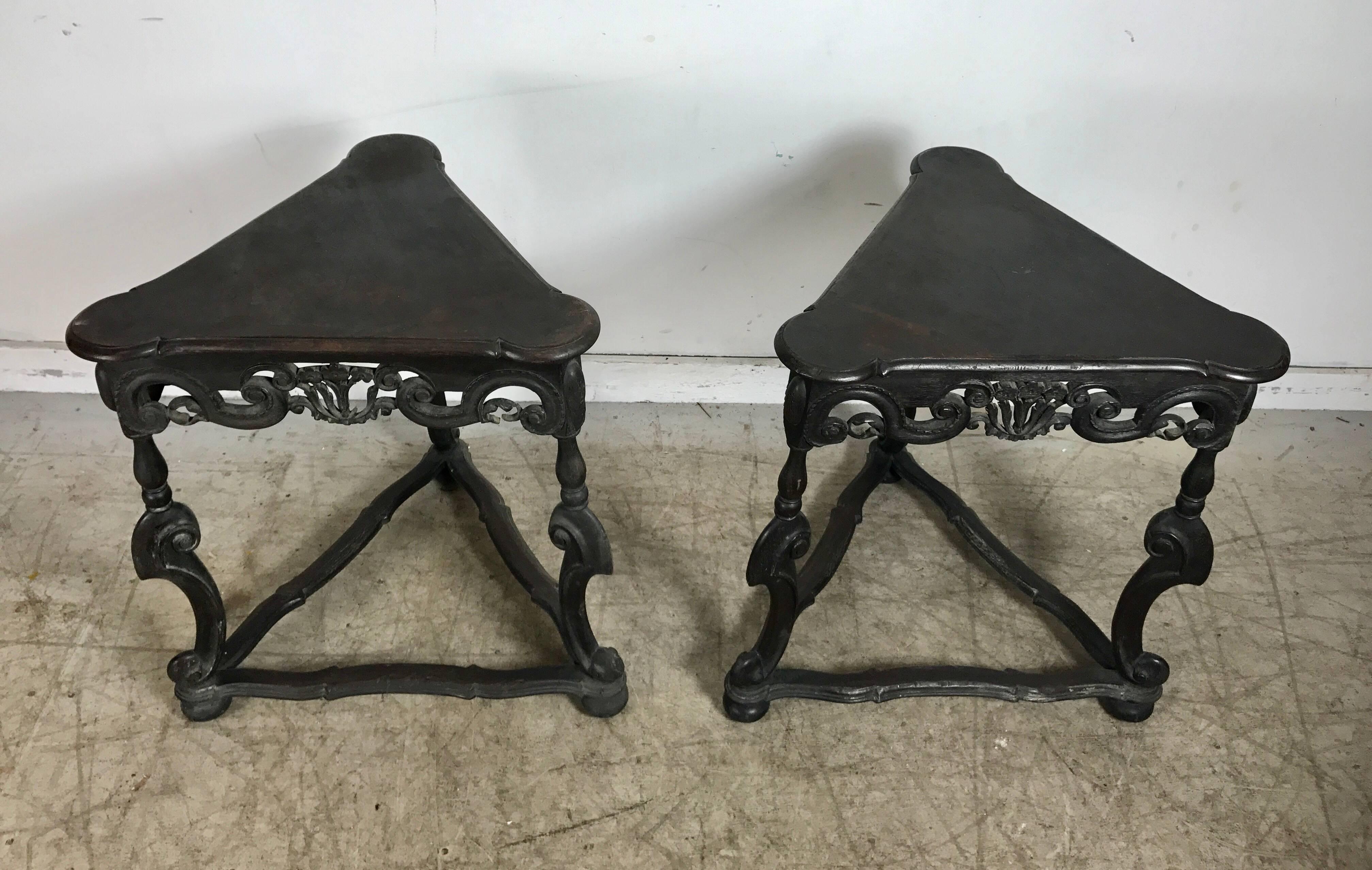 Wonderful matched pair of triangular carved walnut Rococo Revival occasional tables, Italian or Spanish in origin, circa 1920s beautiful warm original finish.