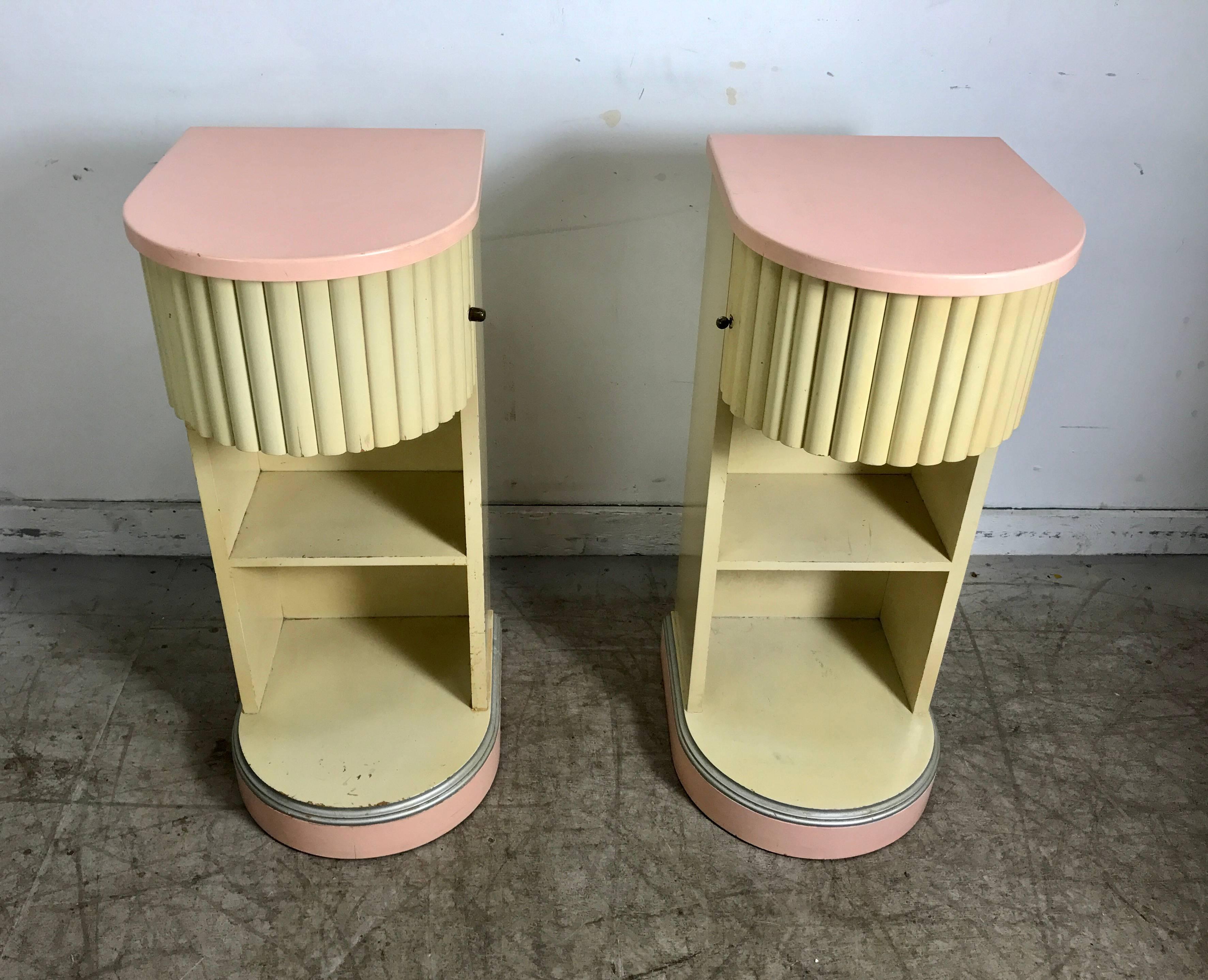 Stylized Art Deco two-tone lacquer nightstands manufactured by Kittinger Furniture, Buffalo New York, The Doric line was introduced in 1934 rounded swing out door, stands tri color salmon, off-white and silver fluting.