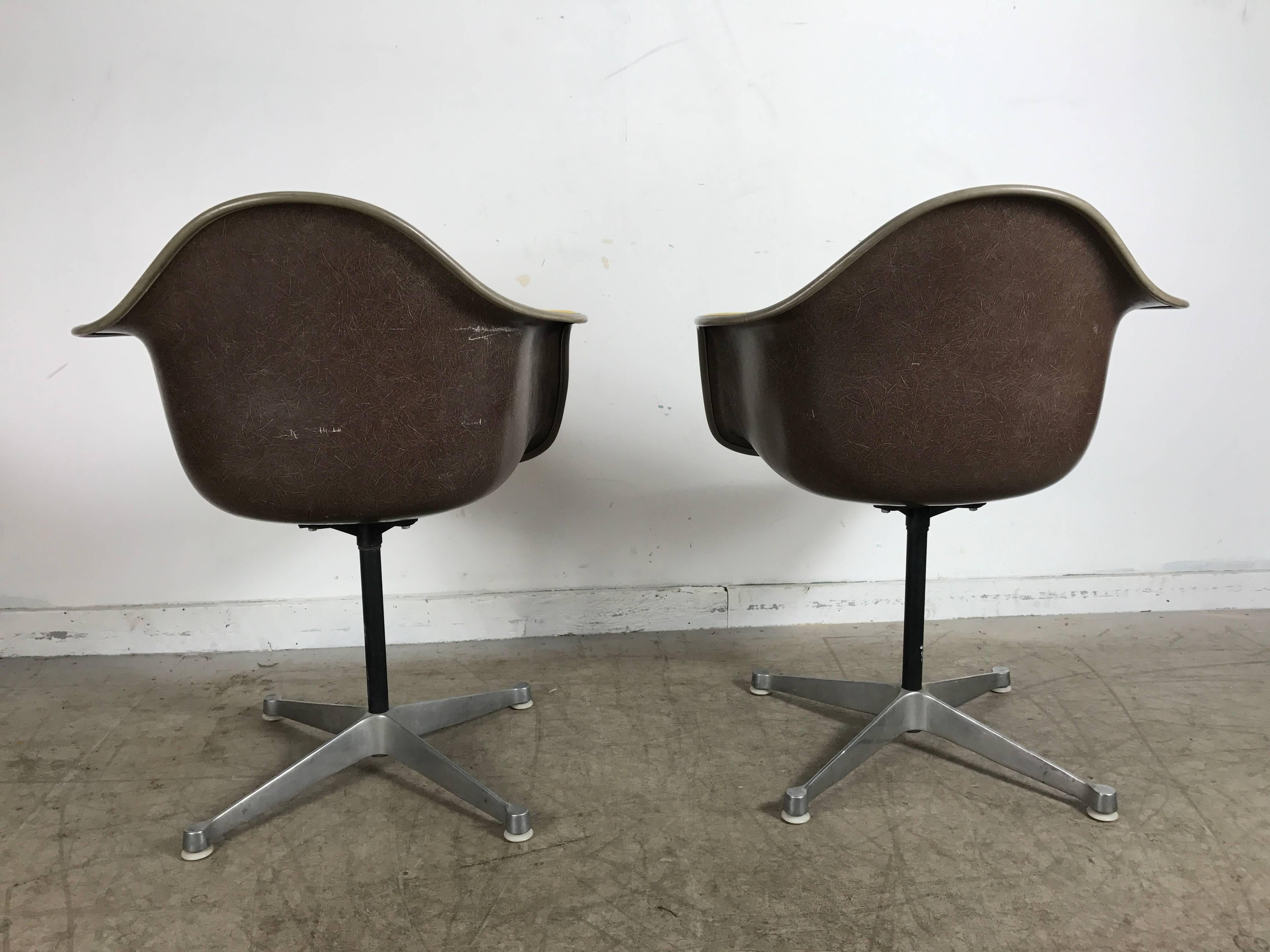 American Pair of Charles and Ray Eames Swivel Padded Arm Shell Chairs, Two-Tone For Sale