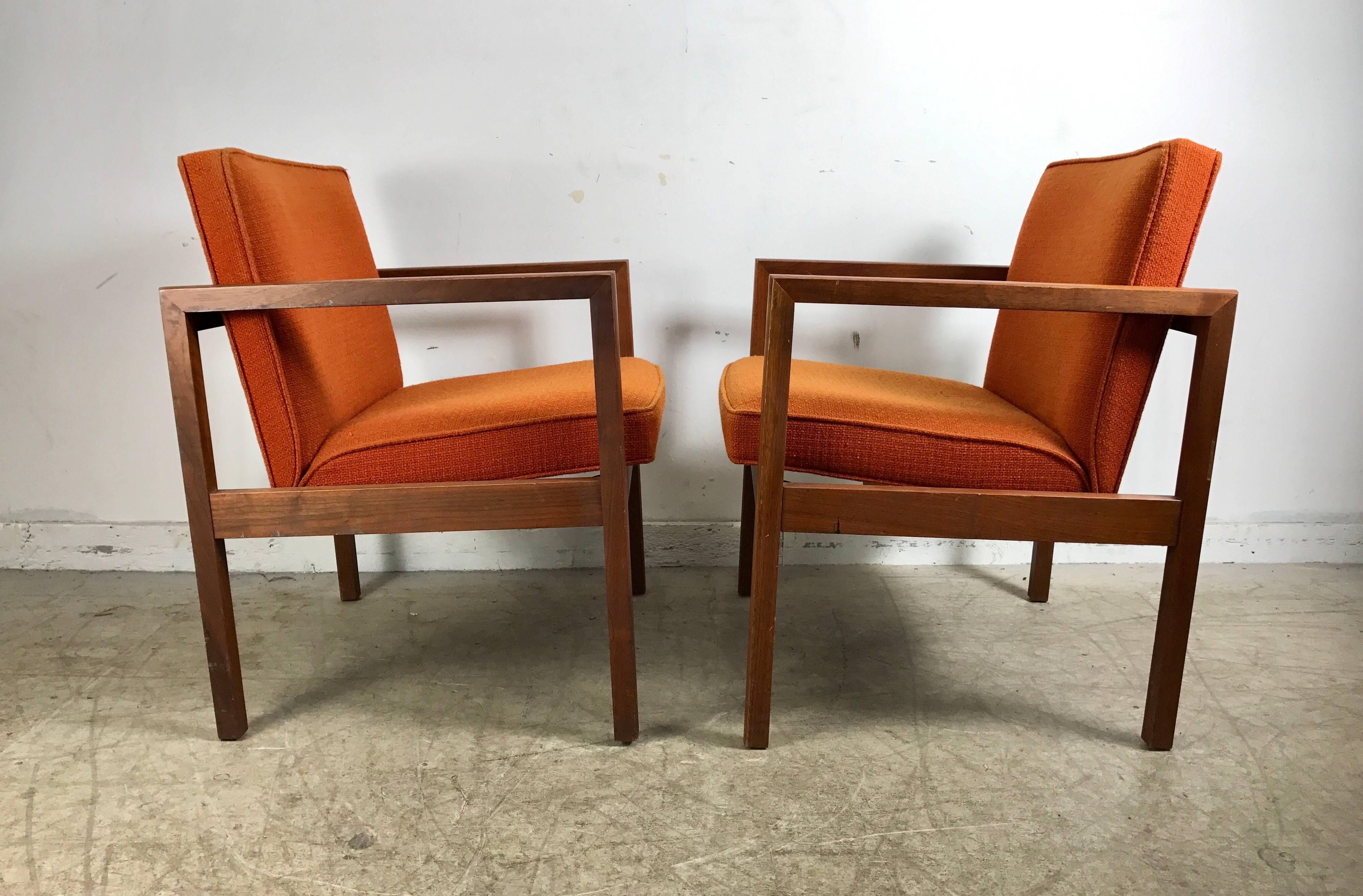 Pair midcentury solid walnut lounge chairs by Stow Davis, handsome architectural profile in the style of Jens Risom. Superior quality and construction, retains original orange wool fabric, extremely comfortable. Hand delivery avail to New York City