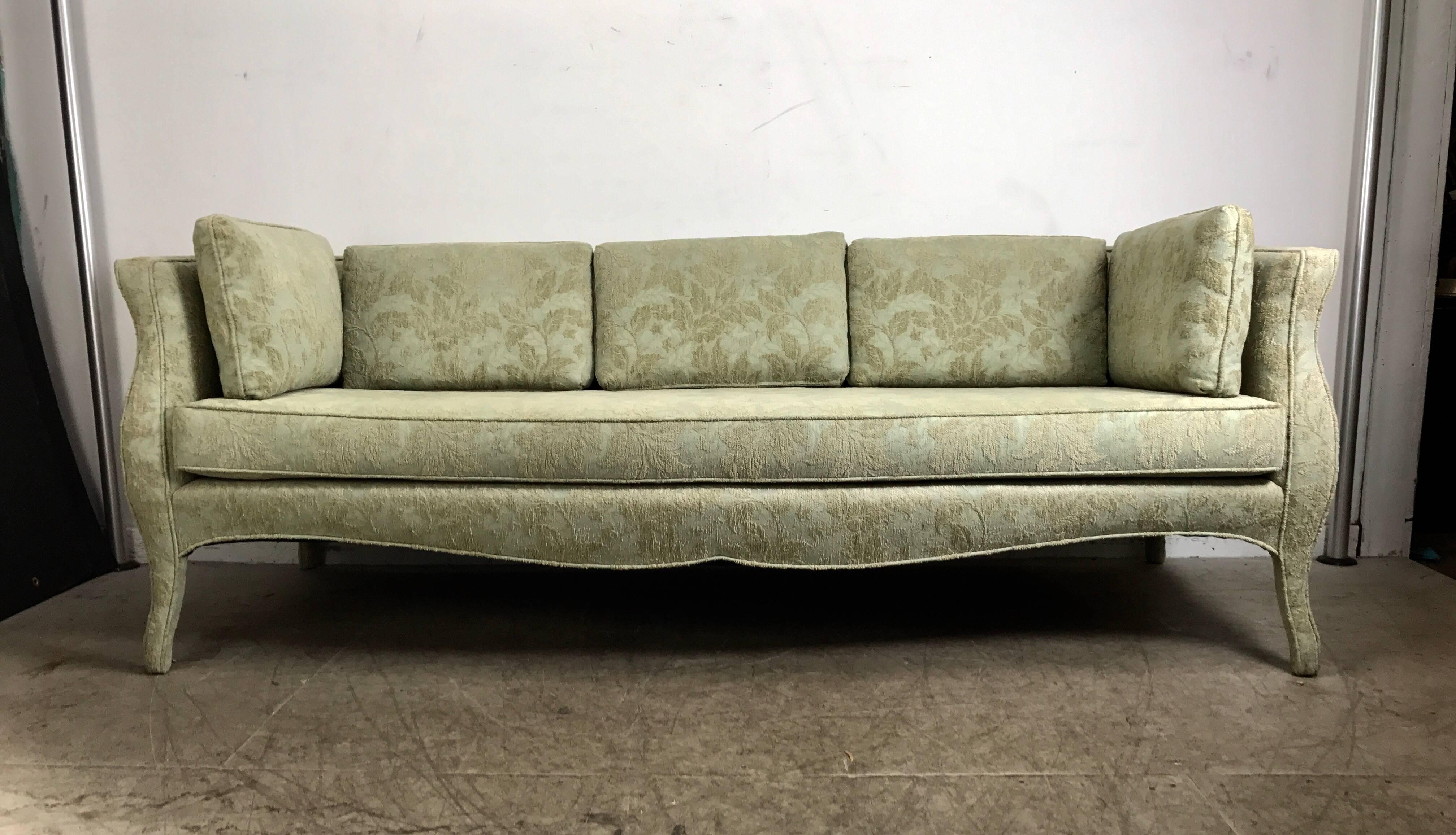Unusual Sofa, Bombay shape, upholstered legs, Baker Furniture. Retains original celadon green fabric upholstery, Fits seamlessly into any environment, Stunning